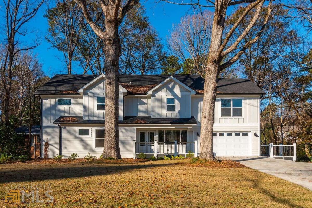 Welcome to Ashford Park in the highly sought after Chamblee Charter school district! This FULLY RENOVATED 5 bedroom, 5 bath modern farmhouse is situated on a spacious corner lot. As you approach, you are met with a cozy front porch and double French doors that open up to the home. Upon entering, you are greeted by a bright and open floorplan. The charming family room  with large windows is the perfect setting for entertaining family and friends as it opens up to the exquisite chefCOs kitchen. This incredible space boasts quartz counter tops, ample cabinet space, a large island, beautiful chevron-patterned marble backsplash, separate built-in wall cabinetry with a wine bottle rack. Completing the kitchen are high end, energy efficient appliances including an Instaview door-in-door refrigerator, built-in gas range with cooktop, microwave and dishwasher powered by LGCOs ThinkQ smart control app. French doors open up to an oversized deck which is the perfect setting for large gatherings. The main floor also features a home office with an adjacent full bath. The upper floor greets you with a cozy loft space perfect for a childrenCOs nook or reading area. The oversized, primary suite features beautiful windows with tons of natural light and double closet space. The elegant, primary bath encompasses a spa-like feel and boasts double vanities, a free-standing soaking tup, large walk-in shower with rain shower head and beautiful glass doors. Also on the upper floor are two oversized bedrooms with adjoining bath. An additional secondary bedroom and ensuite bath is located on the opposite wing of the upper floor. Completing this floor is a laundry room. The finished terrace level, with separate entrance, includes a generous living space, full bedroom, full bath, laundry room, and ample storage. Just outside the terrace level is a notable lower deck. The leveled backyard is private and creates a peaceful setting in the middle of Brookhaven. This beautiful home is conveniently located to shopping, entertainment, parks, and I-285 and GA-400. NOTE:   This home was originally built in 1954 but was taken down to the foundation and reconstructed in 2021.