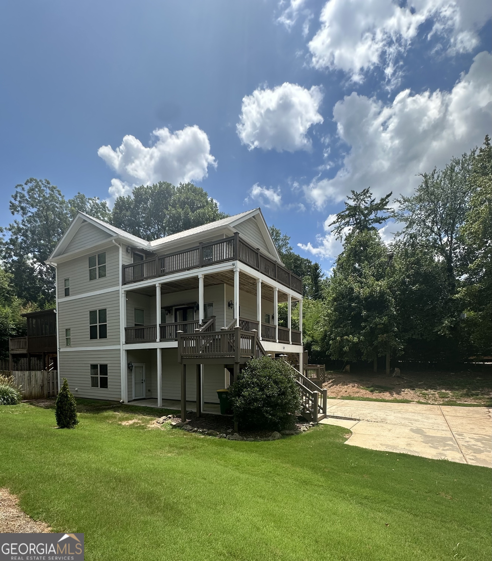 What a spectacular slice of Athens paradise. Situated in the heart of DAWG country and boasting unsurpassed convenience to Downtown Athens, the Classic Center, Dooley Field at Sanford Stadium and UGA-this showcase craftsman is a true CLASSIC! Upgraded with standout appointments and move-in ready condition, this "Charleston-styled" tri-level boasts a dynamic plan that definitely stands out. As you approach, the verdant, lush lawn accented by hard-scape draws you in. Greeted with double piazza decks, outdoor living options are definitely not limited. Welcomed by the main floor you're immediately taken back by this homes conversation piece, the 3rd floor balcony overlooking the great room. The palatial ceilings adds immense charm, and allows natural light to engulf the space. Quite spacious, the great room is the perfect gathering spot, and boasts a fireplace as well offers the quintessential entertaining layout overlooking the kitchen. Well equipped and stacked with upgrades, the gourmet kitchen features it all-Custom cabinets accented by a tile backsplash, butcher block counters offer ample space for meal prep, even more space is provided with the granite-topped island, not 1 but 2 pantry options, and was recently upgraded with a completed stainless appliance package. To ensure ample seating for all, the kitchen offers an extended, raised breakfast bar and an oversized sunlit dining room that could easily seat 8+. The main floor is complete with a guest bedroom, perfectly appointed full bath, and the laundry room for added convenience. Ascend the stairs to find an additional all-inclusive bedroom suite with private full bath, as well as the owner's suite. No stone left unturned, the primary is an extraordinary retreat enhanced with a double tray ceiling, spacious closet with shelving, ensuite bath and private access to the 3rd floor balcony with extended views of Downtown Athens. The primary lavatory continues to inspire with a dual-sink vanity, large tiled shower, and Whirlpool tub encouraging relaxation. Where's the upper level balcony you may ask...through French doors this owner's retreat gives way to 360' catwalk balcony with stunning views. It's truly a unique experience and would make the perfect library. Need even more room to expand? The lower level provides an additional bedroom and full bath with private exterior access. Although the wrap-around decks are glorious, you may prefer a more private setting, and the rear screened porch provides the perfect spot for year-round enjoyment. An open-air deck extends off the porch creating the perfect spot for grilling out. Adding to this total package is the fenced rear and side yard perfect for your fur babies, plus an additional storage building tucked away under the rear stairs. Providing an extra sense of security, both HVAC systems as well as the water heater were updated within the last year. Superior Convenience, Sought-after Location, and Upgraded Features combine to create the cool vibe that is N. Poplar Street!!