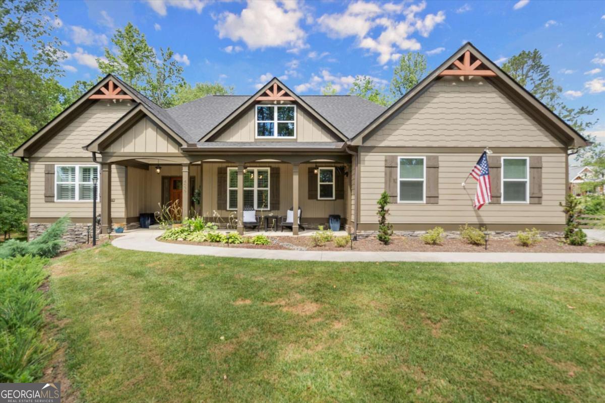 Look no further-this beautifully maintained ranch offers the best of main-level living with a bonus...full, partially finished terrace level, all nestled on a serene 2.47-acre, level lot in sought-after Ball Ground, GA. With no HOA, room to spread out, and endless possibilities, this property is a true gem! Step inside to find a gorgeous kitchen featuring top of the line stainless appliances, gas range, double ovens and a massive island that overlooks the spacious, fireside family room with coffered ceiling-ideal for everyday living or entertaining guests. Just off the main living area, an expansive covered rear deck offers the perfect place to relax, dine outdoors, or take in the peaceful views of your private wooded oasis. The backyard is loaded with lifestyle features, including a fire pit, gazebo with lighting and electrical outlets, and an additional barn/workshop-perfect for hobbyists, storage, or future projects. Downstairs, the terrace level offers a generous family/media room, bedroom and full bath, and a bright flex room-ideal as an office, craft room, or even a 5th bedroom with the addition of a closet. A large unfinished area offers space for a workshop, gym, or storage and opens to the lower-level patio and yard through a separate exterior entrance. The terrace level also has its own driveway and private entry, making it perfect for guests, multigenerational living, or rental potential-plus space to park two additional vehicles. Located just a few miles from charming Downtown Ball Ground and all it has to offer...shopping and dining and easy access to top-rated Cherokee County schools, this peaceful and versatile property is the perfect blend of rural tranquility and convenience. RARE OPPORTUNITY! Take over a low 4.375% Interest Rate...significantly below today's market rates-subject to lender approval and buyer qualification.