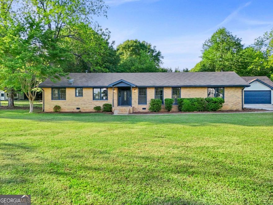 Welcome to this updated four-sides brick ranch in the heart of Fayetteville. With 2,187 square feet of living space, this home offers comfort, convenience, and modern touches. It features 3 spacious bedrooms with ceiling fans and 2 remodeled bathrooms and new showers. Converted 2-car garage is now a flex-space, perfect for entertaining or relaxing. The eat-in kitchen includes stainless steel appliances-cooktop, wall oven, and dishwasher. Den/ Dining room offers charming fireplace. Large laundry room just off kitchen provides easy access to the detached 4-car garage, which includes plenty of space for a desk or office space, a lean-to, and attic storage. Enjoy morning coffee on the screened-in back porch overlooking the fenced backyard, ideal for gatherings and play. Recent updates include a new HVAC system (August 2024), gas water heater, gas furnace, Soffits have also been recently replaced and painted. The seller WILL offer help with closing costs. Don't miss out! Schedule your showing today!