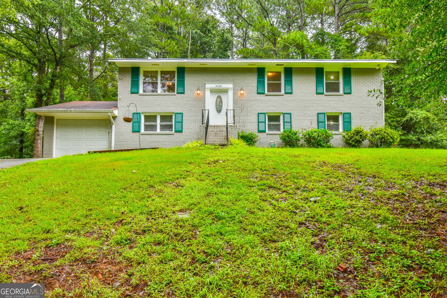 Welcome to this split-level home that offers an inviting and spacious layout, perfect for family living and entertaining. As you approach the house, you are greeted by a charming exterior featuring light gray brick and accents of teal shutters, which evoke a sense of warmth and character. The property is surrounded by lush greenery, providing a tranquil backdrop and ample privacy. Upon entering the home, you are welcomed by a well-lit foyer that leads you to the upper level. This open-concept space is filled with natural light, thanks to large windows that offer stunning views of the surrounding woods. The room seamlessly flows into the dining area, which features elegant lighting that sets a warm and cozy ambiance for family meals and gatherings. Just off the dining area, you'll find a lovely deck that extends from the kitchen-perfectly designed for outdoor dining and entertaining. This deck not only provides a wonderful space to relax but also offers an enchanting view of the backyard surrounded by greenery, ideal for both recreation and relaxation. The kitchen is designed with rich wooden cabinetry, providing both style and functionality. The beautiful granite countertops provide ample workspace. Continuing down the hallway, you discover three spacious bedrooms, each with generous closet space and large windows that allow natural light to pour in. The bathroom offers a relaxing retreat with a modern design, featuring a combination bathtub and shower, along with a stylish vanity that complements the overall decor. Heading downstairs, the lower level features a substantial space that can serve multiple purposes-a family room, play area, or even a home office. A well-appointed bathroom is also on this level, perfect for guests and family alike. Don't miss the opportunity to make this charming house your new home.