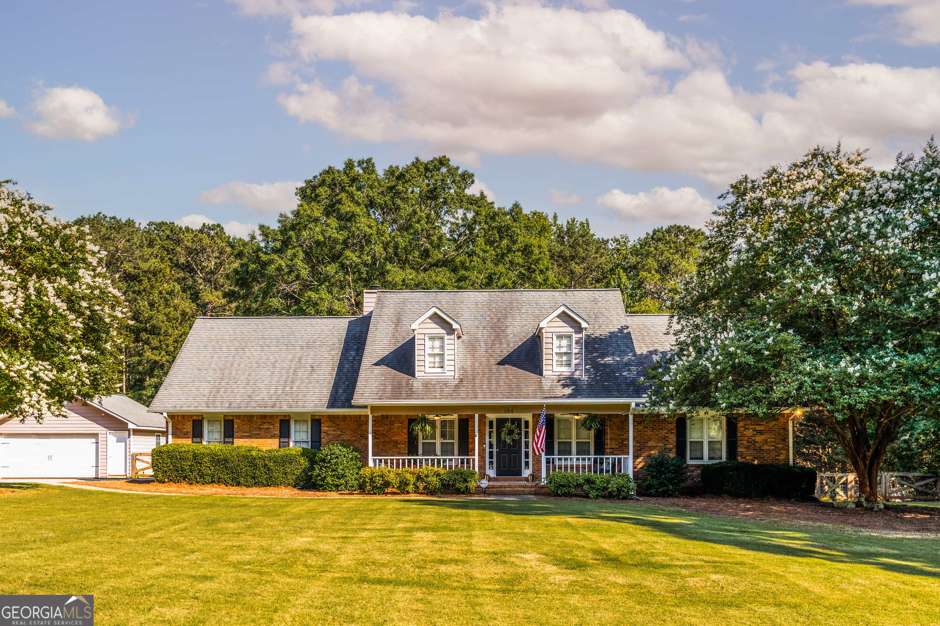 Welcome to 184 Wildflower Drive in the heart of Social Circle, GA-a beautifully updated 6-bedroom, 3-bathroom home nestled on a private 1.27-acre lot in the sought-after Azalea Farms community. This spacious 3,308 sq ft residence blends classic Southern charm with modern convenience, featuring a welcoming front porch, an open-concept main living area with hardwood floors, and a cozy brick fireplace that flows seamlessly into the dining space. The kitchen is a true highlight, boasting bright white cabinetry, quartz countertops, stainless-steel appliances, a tile backsplash, a pantry, and a sunny breakfast nook. The main-level primary suite offers a relaxing retreat with double vanities, a soaking tub, and a separate shower. Two additional bedrooms and a full bath on the main floor provide ample space and flexibility for guests or a home office setup. Upstairs, you'll find three more bedrooms, a full bathroom, two bonus rooms, and a dedicated office-perfect for large families or anyone in need of extra living space. Outside, the property continues to impress with an above-ground pool, a children's playground, a 3616 RV shed, a 2-car detached garage, and a 1216 workshop-ideal for hobbyists or those needing extra storage. With no HOA, you'll have the freedom to truly make this property your own. Located in the desirable Social Circle City school district and just minutes from charming downtown shops, dining, and parks, this home offers both tranquility and convenience. Priced at $504,900, 184 Wildflower Drive is a rare opportunity to own a move-in-ready home with space to grow and room to live-inside and out.