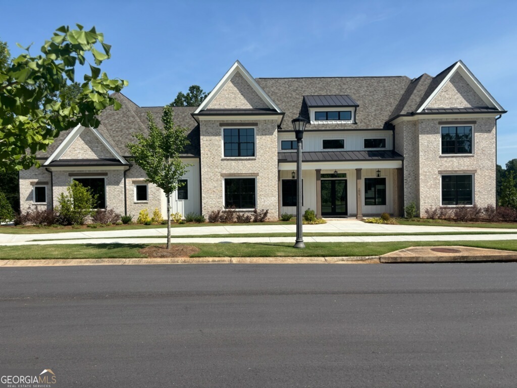 DFW Ventures built ! Nestled on the "Black 4" Fairway of The Georgia Club, this stunningly crafted DFW Ventures home offers an unparalleled living experience in a sought-after gated luxury community. The exquisite double glass door entry floods the home with natural light, welcoming you into a space defined by its dramatic open rail staircase and expansive wall of windows with sweeping views of the golf course. Every detail of this home exudes elegance. The open-concept design features a fireside Great Room with refined floating shelves and a decorative designer ceiling, while the Chef's Kitchen dazzles with custom cabinetry, high-end Quartz finishes, farm sink, pot filler, and state-of-the-art DACOR appliances. The expansive island and sunlit breakfast area with double glass doors opens to an outdoor living space complete with stone flooring, decorative ceiling, and an inviting fireplace providing picturesque views! With a four-car garage including a sink and two water heaters, a spacious pantry with custom wood shelves adjacent to a Butler's Pantry composed of a sink and beverage cooler, this home is designed for convenience and luxury. The main level offers a split bedroom plan for privacy, including a guest suite with walk in shower and a primary suite that boasts a designer wall, decorative ceiling treatment, his and her closets with custom shelving, a luxurious bath with walk-in shower, free standing soaking tub, two vanities with a custom stack of wall cabinets. The generous Laundry Room features custom cabinetry that provides ample storage, along with a convenient laundry sink to handle all washing needs efficiently. Adjacent to it, the Mudroom/Office showcases a built-in work center that caters to productivity, while the mud bench offers a practical spot for organizing outerwear and footwear. The modern shiplap wall adds a touch of contemporary elegance, enhancing the space's aesthetic appeal. Additionally, the inclusion of a half bath is a considerate touch that adds convenience for both residents and guests. This area seamlessly connects to the patio, creating an inviting flow for indoor-outdoor living and entertaining. Upstairs, a loft area and 4 bedrooms each with private baths offer versatile space for family needs. With the lawn maintained by the HOA and numerous amenities, this custom dream home is just minutes from upscale shopping and the renowned UGA campus!