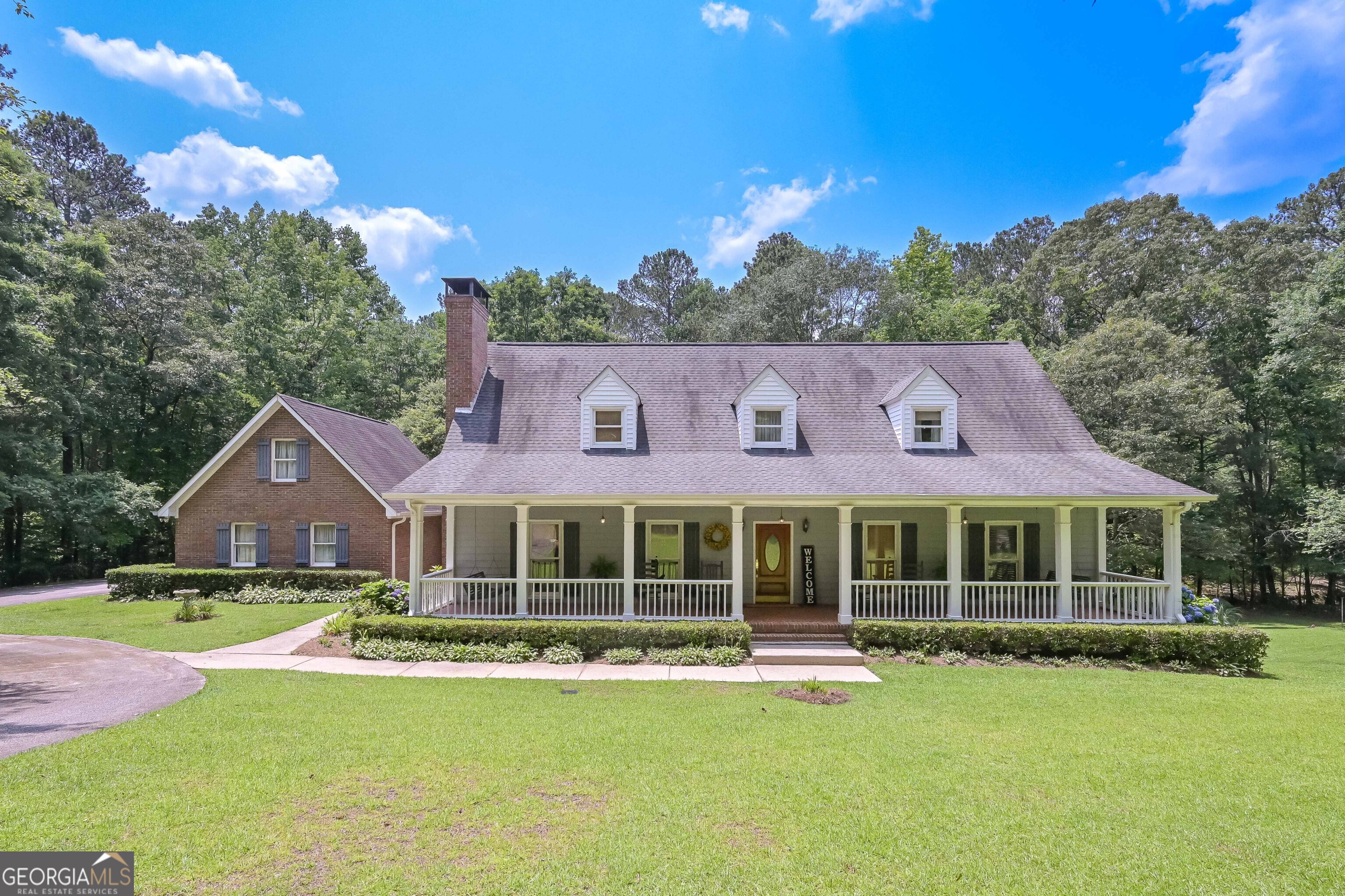 GORGEOUS CAPE COD HOME NESTLED ON 5.246 WOODED ACRES! THIS HOME IS BEAUTIFULLY LANDSCAPED AND HAS AN AMAZING OVERSIZED FRONT PORCH. UPON ENTERING THE FOYER, YOU IMMEDIATELY NOTICE THE GORGEOUS HARDWOOD FLOORS AND THEY CONTINUE THROUGHOUT THE MAIN LEVEL OF THE HOME. THE LIVING ROOM IS SPACIOUS AND HAS A BRICK WOOD BURNING FIREPLACE THAT IS OPEN TO THE FORMAL DINING AREA. THE KITCHEN HAS GRANITE COUNTERS AND PLENTY OF CABINET AND COUNTER SPACE. THERE IS A PANTRY FOR MORE STORAGE. THE HUGE BREAKFAST AREA IS OPEN TO THE KITCHEN AND HAS LOTS OF NATURAL LIGHT COMING IN. IT IS ALSO OFF OF THE LARGE SCREENED PORCH THAT OVERLOOKS THE BACKYARD. FOR CONVENIENCE, THERE IS A HALF BATH FOR GUESTS ON THE MAIN LEVEL. THIS HOME FEATURES A LARGE LAUNDRY ROOM ON THE MAIN LEVEL WITH TILE FLOORS. THE MASTER BEDROOM IS ON THE MAIN LEVEL WITH A WALK-IN CLOSET. THE MASTER BATH HAS 2 SEPARATE VANITIES WITH GRANITE COUNTERS AND ONE HAS A BUILT-IN VANITY AREA. THE MASTER BATH ALSO FEATURES A GARDEN TUB AND SEPARATE TILE SHOWER WITH FRAMELESS GLASS DOOR. UPSTAIRS YOU WILL FIND 2 EXTREMELY LARGE BEDROOMS WITH WALK-IN CLOSETS AND THEY SHARE A JACK & JILL BATHROOM. FOR ADDITIONAL STORAGE, THERE IS A FULL UNFINISHED DAYLIGHT BASEMENT WITH BRICK WOOD BURNING FIREPLACE. THERE ARE 2 EXTERIOR ENTRANCES TO THE BASEMENT AND ONE OF THOSE IS A GARAGE/BOAT DOOR FOR LAWN EQUIPMENT. THIS HOME IS VERY LOW MAINTENANCE WITH 3 SIDES BRICK, ALUMINUM SOFFITS & FASCIA AND VINYL CEILINGS ON THE FRONT PORCH. THIS HOME ALSO OFFERS SURGE PROTECTION FOR THE ENTIRE HOUSE AND A 2 CAR ATTACHED GARAGE. THIS HOME HAS BEEN WELL MAINTAINED AND IS A MUST SEE!