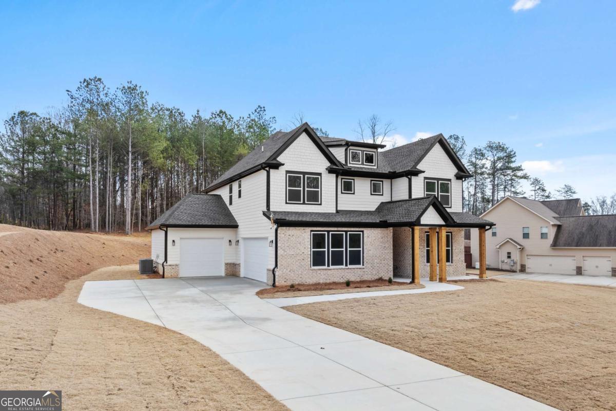 Welcome to your Custom Built 5Br 4Ba Dream Home, nestled within a Prestigious Gated Lake Lanier Access Community. Situated on a Beautifully Landscaped one-acre lot, this Marvel offers the Perfect Blend of Luxury, Space and Modern Design. Upon entering, you'll find a Versatile first-floor In-Law/Teen/Guest Suite and Full Bath. A spacious Flex Room offers the perfect space for a Home Office, Arts and Crafts or Additional Living Area. The Open-Concept Main Level boasts a Chef's Kitchen featuring a Stunning Oversized Center Island, White Cabinetry, Stainless Steel Appliances and Built-in Shelving, creating the Perfect Ambiance for Relaxation and Entertaining. The Three-Car Garage provides Ample Parking and Storage. On Upper Level, Retreat to the Oversized Owners Suite showcasing a Luxurious En-Suite Bath with Dual Vanities, a Ginormous Custom Built tiled Walk-in Shower and Dual Walk-in Closets. The Upper Floor also Showcases Three Additional Bedrooms, Two Full Bathrooms, an oversized Laundry Room with Sink and Sotrage and a spacious Loft Area, perfect for a Media Room or Play Area. This Amazing Home Offers Modern Elegance, Upgrades Throughout and an Unbeatable location near Lake Lanier. Don't miss this opportunity to make it yours. Schedule a Tour today! WELCOME HOME!!!