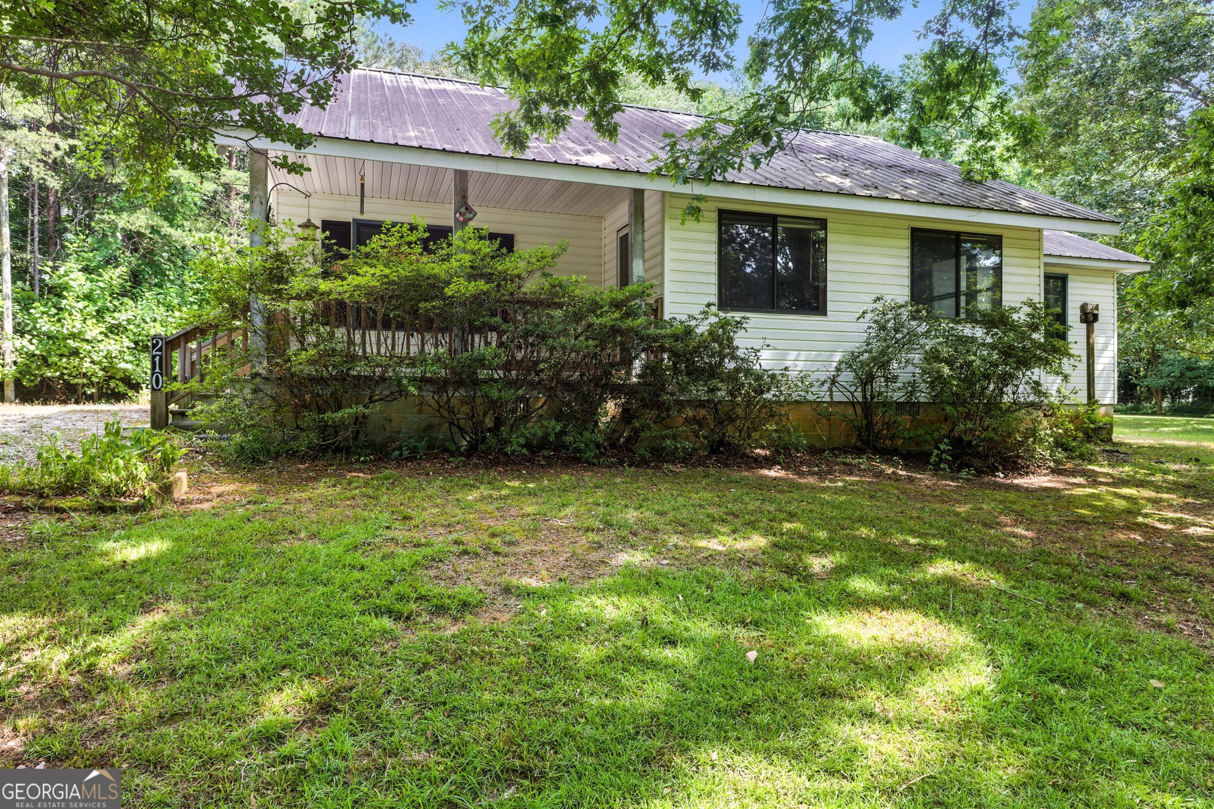 blend of convenience and privacy in this charming 3-bedroom, 2-bath home located in the heart of Demorest, just a short walk to Piedmont University. Tucked away on a quiet back street, this property offers easy access to both Hwy 441 and Hwy 365 while maintaining a peaceful, tucked-away feel. The large side yard provides plenty of space for outdoor activities, gardening, or simply relaxing in the fresh air. A versatile pole-barn style workshop or carport sits beside the home, ideal for storage, hobbies, or covered parking. Whether you're seeking a comfortable primary residence or an investment in a prime location, this property checks all the boxes.