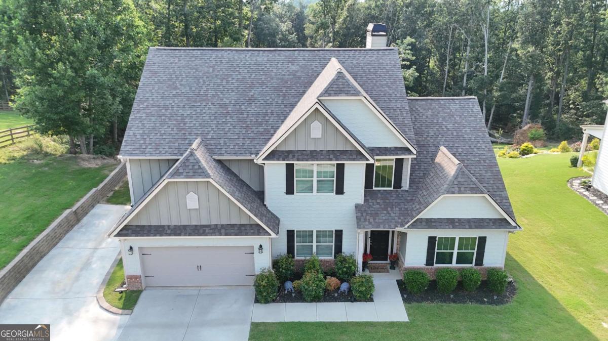 Tucked away on a quiet street in Rydal, 31 Thunderhawk Lane offers a blend of space, design, and comfort across more than 3,000 square feet. Set on a .78-acre lot, this 4-bedroom, 3.5-bathroom home delivers a flexible layout that works whether you're hosting, working from home, or simply enjoying daily life. The main level features a dedicated dining room just off the foyer and opens to a large living area with a soaring ceiling and a striking stone fireplace. The kitchen is finished with granite countertops, stainless steel appliances, and an island that doubles as a prep station or breakfast bar. A casual dining space sits just off the kitchen with views of the backyard. The primary suite is also on the main floor and offers privacy along with an ensuite bathroom that includes dual sinks, a soaking tub, separate shower, and a walk-in closet. Also on the main level are a half bath for guests, a laundry room, and access to the two-car garage. Upstairs, you'll find three well-sized bedrooms and two full bathrooms. One bedroom features a private ensuite, while the other two share a hall bath. A loft area provides a flexible space for a media room, study, or second living area. Out back, the covered patio includes a ceiling fan for comfort and shade, making it an easy place to relax or entertain. The backyard is wide and open, ready for whatever use fits your lifestyle. Located just a short drive from Cartersville and I-75, this home offers peaceful living without sacrificing convenience. With thoughtful features throughout and space where it matters, 31 Thunderhawk Lane is ready for its next chapter. Schedule your showing today.