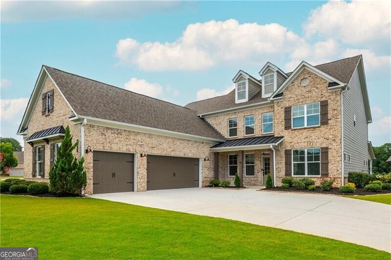 Nestled in a prime central location with excellent schools, this stunning West Cobb estate home offers an incredible style of living with a flexible layout that is flooded with natural light, all with the backdrop of a picturesque community lake. This large corner lot has a fully fenced private backyard with a massive covered terrace, outdoor fireplace, and huge amounts of front and side yard -- and since this home sits on a quiet cul-de-sac street, it's the perfect space for all kinds of outdoor activities. Step inside and you will find a beautiful dining room with coffered ceilings and a separated private office space -- then enter into the huge heart of the home! The grand great room centers around the gorgeous stacked stone fireplace and the giant sliding glass wall that combines the indoor/outdoor living spaces into one. Part of the heart of this home is the chef's kitchen with a double oven, gas cooktop, butlers pantry, and a massive walk-in storage pantry. The spacious open-concept kitchen also has beautiful quartz countertops, ample cabinetry, a large island, breakfast bar, and full eat-in dining space - all opening up to the spectacular terrace -- ideal for entertaining or everyday life. The main-floor primary suite is a true retreat, offering privacy, lake views, and a spa-like ensuite bath with massive multi-rainhead shower, huge custom-built walk-in closet, AND direct access to the gigantic laundry room, which features a utility sink, storage cabinetry, and mudroom. Upstairs you will find three additional bedrooms, one bedroom with a private en-suite bath, and two bedrooms sharing a large double-vanity bathroom, all centered around an enormous flex-space loft that is perfect for a game room, homework space, art studio, or any other combinations! This type of home is an increasingly harder find in West Cobb for under $1M and is all set and ready for it's next chapter!