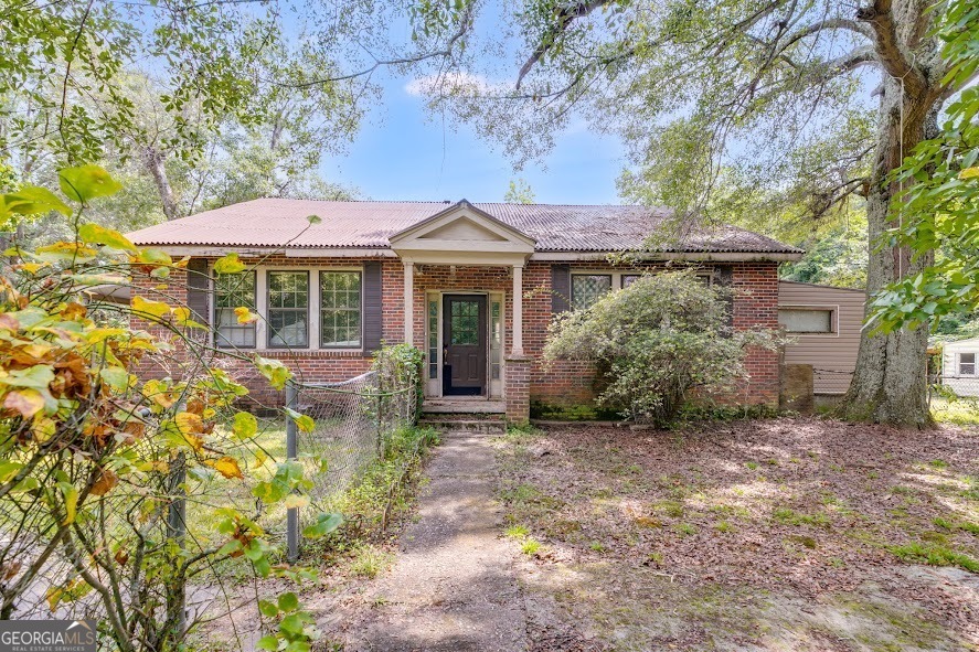 Investor Special! Absolutely dripping in farmhouse charm, you do not want to miss this wonderful opportunity to restore this beauty!  This four-sided brick home sits on the corner of Post Rd and Daniel Mill, on a large 2.50-acre lot. With some TLC this home is bound to be a winner. Has the potential to be converted to a 5 bedroom 2.5 bath home. Could also be parceled out and cleared to add an additional new build with access from Daniel Mill.  Don't delay on this beauty! Call the listing agent for all additional details. Being Sold As-Is Where-Is.