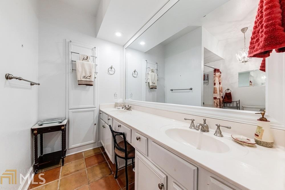Amazing Brookhaven location. Ground level 2 BR/2BA with 2 covered parking spaces and conveniently located near pool and fitness. Kitchen features stainless steel appliances, granite counter tops and white kitchen cabinets that opens to dining and living. Hardwood floors throughout! Large laundry room allowing for full-sized W/D. Gated w/ 24-hour guard.