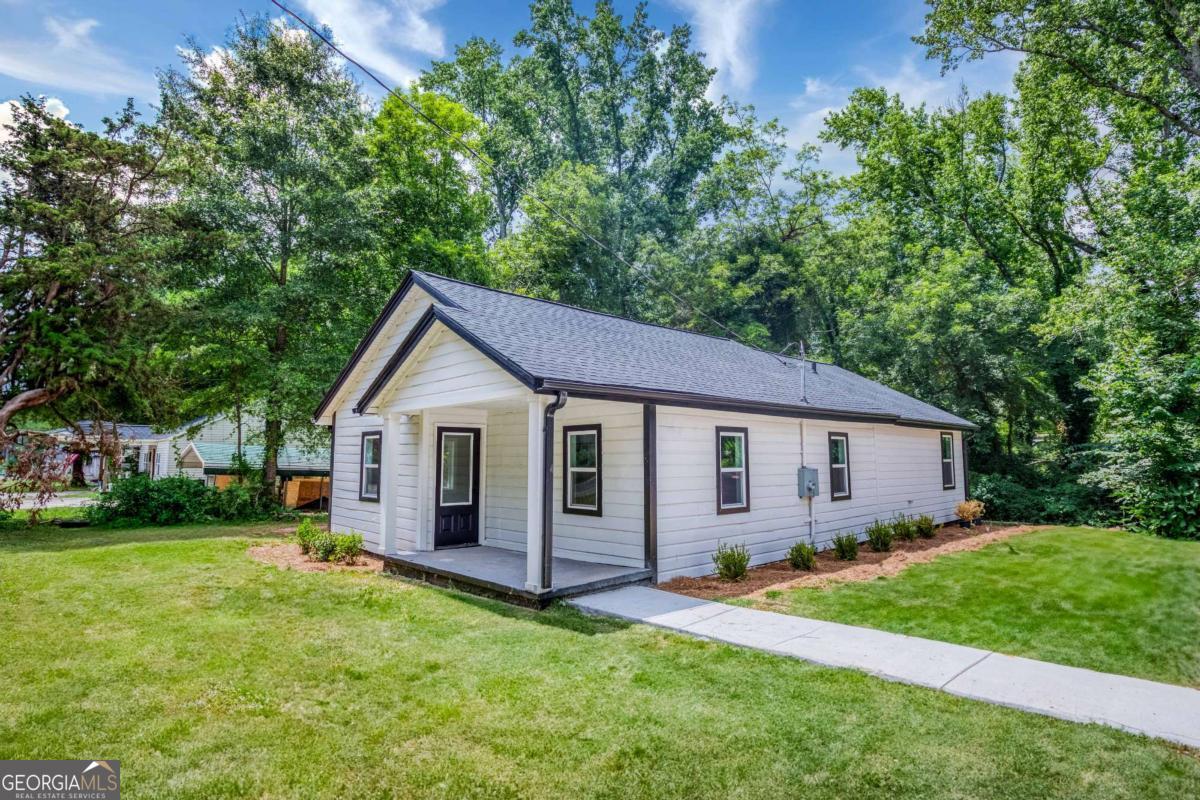 Step into this beautifully renovated 3-bedroom, 1-bathroom single-family home, perfectly situated just minutes from historic downtown Monroe, GA. Originally built in 1940, this 1,170 sq ft home was fully updated in 2025 with modern comforts while preserving its classic charm. Sitting on a generous 0.44-acre lot, this home features an open-concept layout with brand-new vinyl flooring throughout, a stylish kitchen equipped with all-new appliances, and a spacious living area ideal for entertaining. The home is fully electric and offers central heating and air for year-round comfort. Additional upgrades include a brand-new roof, a freshly poured driveway, and contemporary finishes throughout. Whether you're a first-time homebuyer or an investor looking for a turnkey property in a growing area, this home is a must-see. Don't miss this opportunity to own a piece of Monroe with modern updates and timeless appeal!