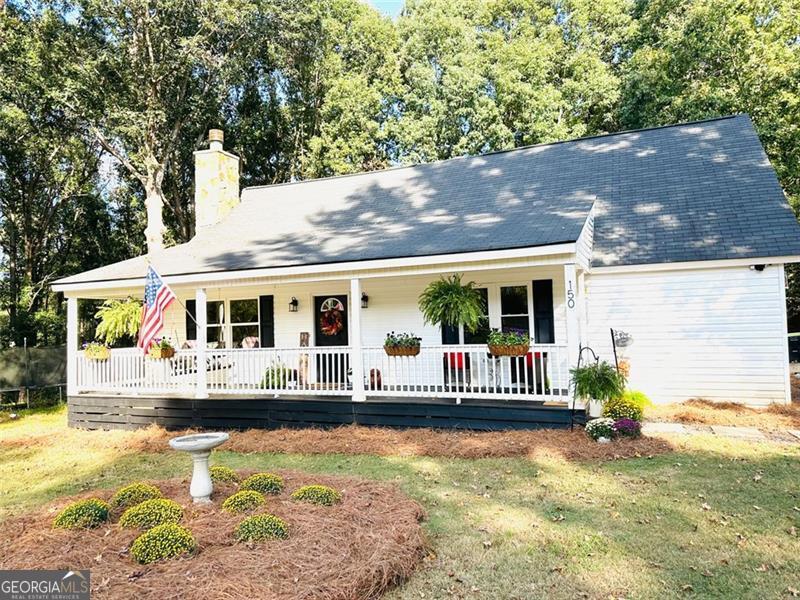 Welcome to your country getaway! This beautiful GATED farmhouse sits on almost 10 acres (9.98) of peaceful, quiet land, perfect for anyone looking for space, privacy, and room to roam. The home features a large front porch with a classic swing, the ideal spot for morning coffee or watching the sunset. Inside, you'll find 4 bedrooms and 3 full baths. The main level offers three bedrooms and two bathrooms, including a spacious primary suite with an updated bathroom, large custom closet, and expansive windows overlooking the forest. Upstairs, you'll find a private guest bedroom and full bath, perfect for visitors or a quiet retreat. The eat in kitchen features "smart" appliances and opens to the Family room, so you're always included in the festivities. Home also features a very large separate 1200 Sq Ft Shop/Garage with ample storage and workspace. Perfect space to house and work on ALL the toys. Additionally, a Lean-to shed, great for housing chickens, equipment, or hobby projects. There is a natural spring/creek that runs along the back of the property. This place truly has it all. With plenty of acreage, this property provides endless opportunities-whether you dream of gardening, raising animals, or simply enjoying the serenity of nature. There is a well on property, but Sellers do not know the current status of it. Be advised: Cameras on property. There are also dogs on the premises, but they are secured by a tether. PLEASE do not approach them. Thank you!