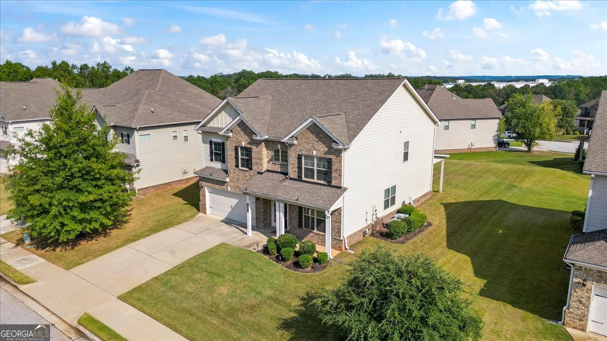 Move-in ready 4-bedroom home in a beautifully maintained community! This spacious home features a flex room, formal dining, and a chef's kitchen with double ovens, gas cooktop, large island, and stone countertops. The oversized primary suite boasts his & hers walk-in closet, double vanities, and a spa-like bath with a garden tub and tiled shower. Enjoy upgrades like whole-house speakers, custom blinds, tray ceilings, and a cozy fireplace in the family room. Step outside to an enlarged covered patio, ideal for relaxing or entertaining. Located in a quiet, established neighborhood just minutes from Conyers shopping, dining, and I-20, with the benefit of lower Newton County taxes. Schedule your private showing today. This one won't last!