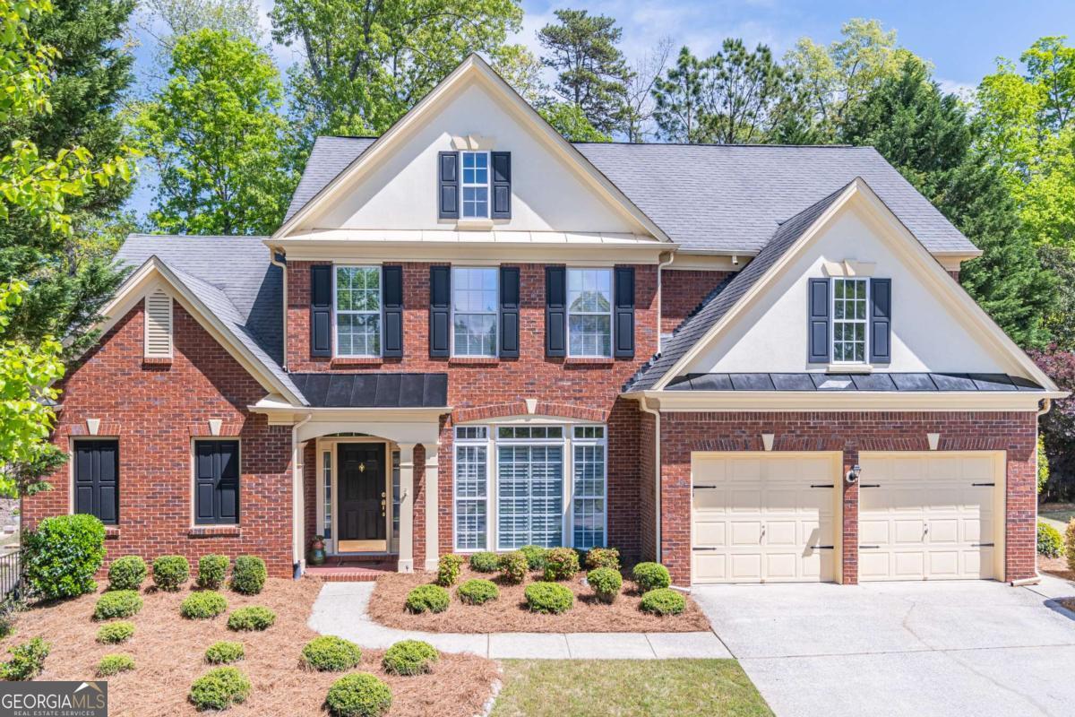 VACATION WITHOUT LEAVING YOUR COMMUNITY = Private setting in a quiet cul-de-sac. Walking/biking to clubhouse/pool/tennis/pickleball and the lake. Beautifully maintained/move in ready with many updates/upgrades. Large owner's suite on main level with an oversized closet and custom closet system, 3 additional large bedrooms upstairs, 1 Jack and Jill bathroom and 1 private bathroom upstairs. Storage room finished off for a playroom or office. 1 additional room/area for hobbies/children's study or a second office. Only home plan with an owner's suite on the main level outside of the active adult (Commons) area of the community, due to wide home plan very few of this model in Longlake and rarely on the market. Don't miss this floor plan. Fresh paint, wood floors, plantation shutters, updated kitchen appliances/HVAC. Large great room with 2 story windows and double sided fireplace from great room to sitting room/informal dining/kitchen, large separate dining room for entertainment off the foyer. Private rear over sized patio, beautifully landscaped with privacy fence blocking views to other homes. Community offers swim lessons/team tennis/pickleball lessons and ALTA teams, boat ramp for Longlake residents only to the 45 acre private stocked lake. Electric engines only. Sidewalks/street lights for walking/biking safely. Recently renovated clubhouse. Recently updated tennis/pickleball courts, new playground in process. South Forsyth lifestyle - close to all 3 level schools within 1 mile as well as several private schools. Close to shopping, restaurants at the collection and Halcyon/hospitals and medical care. Location, location, location - You won't be disappointed.