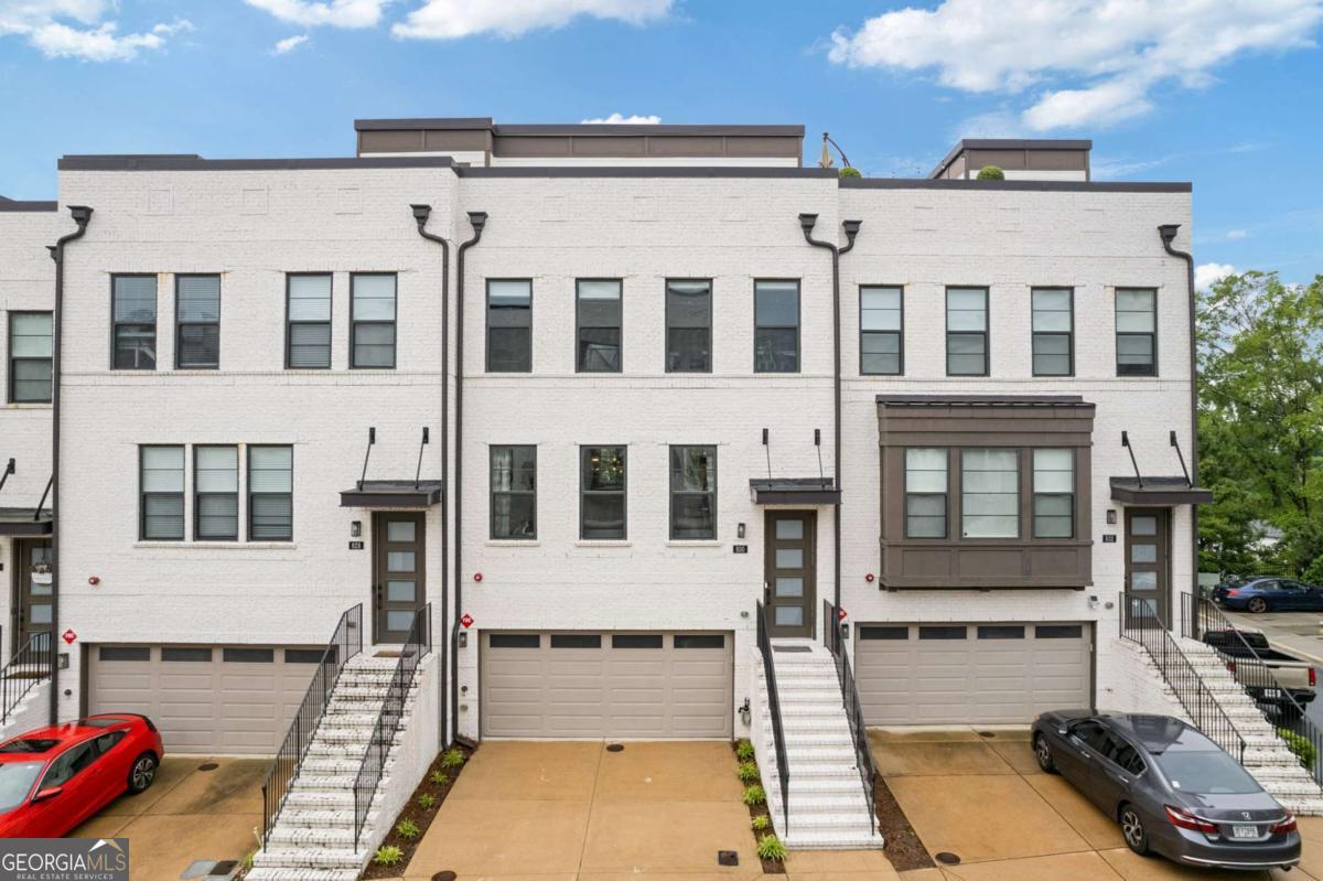 Experience luxurious intown living in this beautifully upgraded 4-bedroom Atlanta townhome, ideally located just minutes from Midtown, Downtown, Shady Valley Park, Roxboro Valley Association Pool & Tennis Club, and the Peachtree Creek Greenway with easy access to GA-400 and I-85. This modern residence offers unbeatable city views from a full enclosed rooftop patio with its own half bath, showcasing panoramic scenes of Midtown, Downtown, and Buckhead. Inside, enjoy an open-concept main level with a gourmet kitchen featuring updated fixtures, a sunroom for year-round enjoyment, and a bright living space. Access to a private, fenced-in patio and yard as well as an enclosed top floor loft like no other unit in the subdivision. Smart home upgrades abound-including Nest thermostats, smart locks, switches, cameras, smoke detectors, and an EV-ready garage with a car charger-along with custom closets, and available purchasable furnishings for a seamless move-in. Select tech items may remain with the home. This move-in-ready property blends clean modern design, city convenience, and comfortable, connected living.