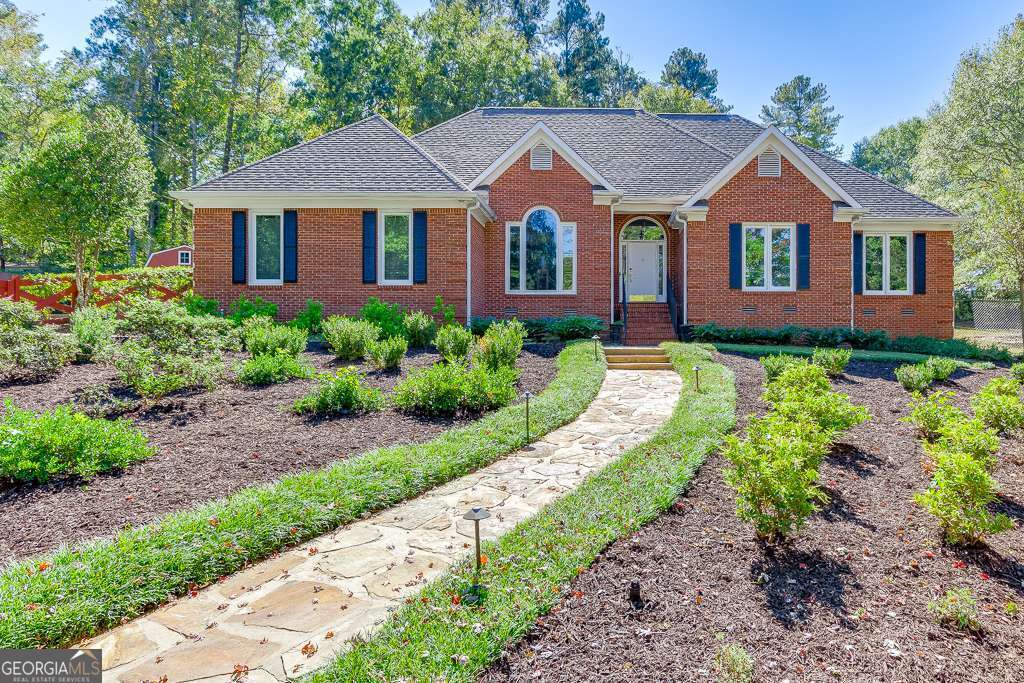 Located in the heart of Oconee County's award-winning school district and just minutes from downtown Watkinsville, this 4 sides brick RANCH on almost an acre is a RARE find in one of Oconee's most desirable areas! This property BACKS UP to the new 100-acre Thomas Farm Preserve, creating ultimate privacy. Positioned in an established subdivision on a cul-de-sac lot, this home has great curb appeal! The picturesque, fenced front yard features an elegant, symmetrical design with a charming stone pathway and curated perennial beds. It is an outdoor space that requires minimal maintenance while delivering maximum visual impact. Upon front door entry to the Foyer, you are greeted by vaulted ceilings, sparkling chandeliers and stunning marble flooring that spreads to the Great Room ahead, Dining Room on the left, and through to the Kitchen. A built-in desk (or coffee bar), granite island with seating, floor to ceiling open-pane windows and commodious eat-in area makes for the perfect space to dine and entertain. Off the kitchen you will find a large, walk-in laundry room with cabinets, garage entryway, and access to the back patio/yard. Opposite the kitchen, you'll find two Secondary bedrooms featuring natural hardwood floors, a full, renovated hall bathroom, and the Primary Suite. Natural light beams in the Primary Suite, which hosts a trayed ceiling, His and Hers closets, and a luxury, newly-renovated Primary Bathroom! The Primary Bathroom features His and Hers vanities, floor to ceiling marble tile, frameless shower, and jetted freestanding bathtub. This home features a long list of upgrades - Newer 12x20 shed, tankless water heater, new irrigation system, fully renovated bathrooms, open pane windows, to name a few. THIS LOCATION CAN'T BE BEAT! Just around the corner from downtown Main Street - a hub for great shopping, delicious dining, a thriving business, community events, and an arts community. Close proximity to Thomas Farm Preserve and Rocket Park (3 min), Wire Park (6 min), Publix (10 min), Sanford Stadium/Downtown Athens (16 min), Trader Joes (18 min) and easy access to Hwy 441. And to top it all off, this home is located in the highly ranked schools of Oconee Primary, Oconee Elementary, Oconee Middle School and Oconee High School.