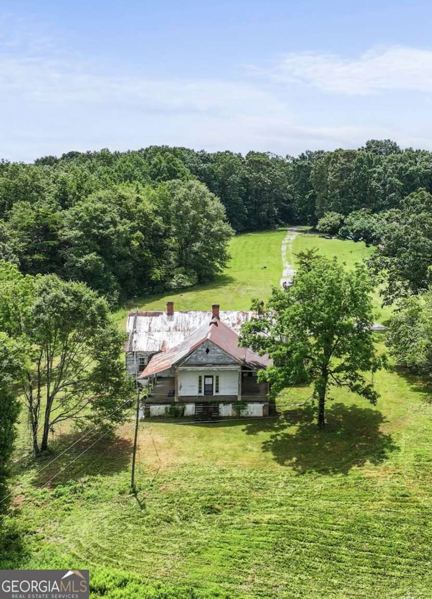 Discover the perfect setting for your dream home on this exceptional 22.57-acre property. Featuring two scenic pastures, existing utilities, and a well already in place, this land offers both convenience and charm. At its heart sits a beautifully preserved 1800s farmhouse-remarkably well-maintained for its age-offering a unique opportunity for renovation or to serve as a temporary residence while you build new. The homesite boasts sweeping views of the pastures and is framed on three sides by serene woodlands. Caribou Ln dead-ends into this driveway/property so it truly is a private, picturesque retreat. A rare and stunning opportunity!