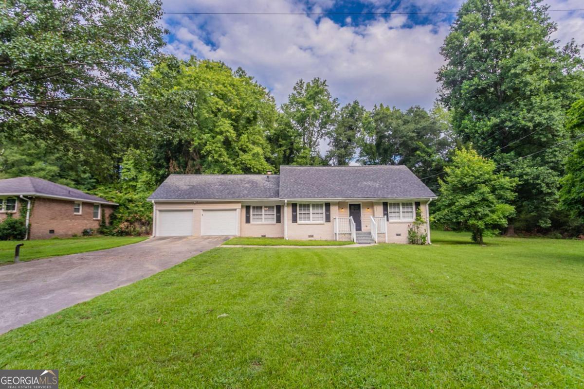 Welcome to this charming 3-bedroom, 2-bathroom home that blends comfort and style. The inviting living room features a cozy fireplace, perfect for relaxing evenings. The kitchen is equipped with stainless steel appliances, crisp white cabinets, and plenty of counter space for meal prep and entertaining. Enjoy your mornings or unwind in the evenings on the screened back porch overlooking the backyard. A spacious 2-car garage adds convenience and storage. One or more photos have been virtually staged. Schedule a showing today!