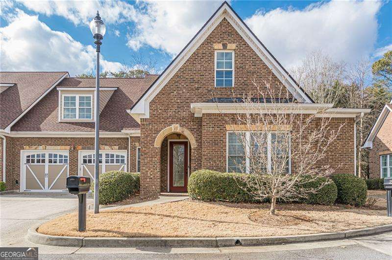 This stunning home offers exceptional upgrades and elegant design in a vibrant over-55 community. The main level features upgraded engineered wood flooring throughout, dual coat closets, two spacious secondary bedrooms, a full bath, and a generous ownerCOs suite with dual closets and a spa-like bath. The open-concept layout includes a separate dining room, a cozy breakfast area, and a chefCOs kitchen equipped with stainless steel appliances, granite countertops, double ovens, and a rare gas cooktop. The living room boasts fireside living, custom built-ins, leading out to a sunroom that opens to a private back patio. The finished upper level includes a large bedroom or office, a full bath, and a versatile rec room with a cedar closetCoperfect as a bedroom, second living area, or flex space. Ample attic storage is available in each upstairs room. Additional highlights include crown molding throughout, tiled bathrooms, a two-car garage, and premium finishes that make this home truly stand out. Nestled in an unbeatable location just off Sandy Plains Road, this home offers effortless access to everyday conveniences. Enjoy having a variety of grocery stores, restaurants, and the post office all within a mile, while top-rated medical facilities and a major hospital are less than five miles away. Whether running errands, dining out, or seeking healthcare, everything you need is just minutes from your door. DonCOt miss this rare opportunity to own a luxurious, low-maintenance home in a thriving community. Schedule your showing today!