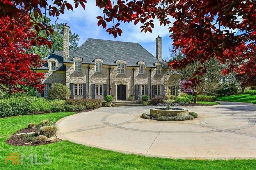 This European gated estate, located near the desirable Chastain Park, boasts an elegant design with six bedrooms, seven full bathrooms, and one guest powder room. The circular drive with a central fountain creates a stately entrance. The impressive foyer features double iron front doors and leads to the formal living room and dining room, both adorned with fireplaces, beautiful surrounds and custom mantels. The light filled French doors open to Juliette balconies overlooking the manicured grounds. An epicurean kitchen offers quartz countertops, top-of-the-line appliances, white shiplap, a true butler's pantry and a wet bar, with wine storage. Off the kitchen, a vaulted breakfast room and fireside family room offer cozy yet chic spaces for everyday living. The main level screened porch boasts a vaulted ceiling and gas fireplace for relaxing evenings. The main level owner's retreat includes an abundance of natural light, a spacious sitting area, and a spa-like en-suite. On the second level reside four full guest suites and a teen/bonus room. The fully finished terrace level is an entertainer's delight, offering a family room with a bar, home theater, gym, and dog wash. Park-like grounds feature a heated pool and spa, perfect for outdoor activities, and a three-car garage for ample parking. Overall, this estate offers a luxurious and comfortable living experience in an excellent location.
