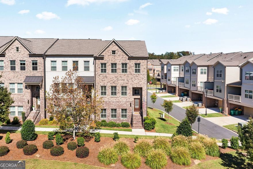 Better Than New Townhome in Prime Downtown Woodstock Location! Welcome to luxury low maintenance living that is just a short distance from the vibrant shops, dining, and entertainment of Downtown Woodstock. This beautifully end unit home is an upgraded 4 bedroom, 3.5-bath townhome that is really better than new, featuring high-end finishes and upgrades throughout, don't miss the custom plantation shutters. The open-concept floor home features an entry-level guest suite with a full bath, perfect for visitors or a home office. The chef's kitchen is one of the "WOW" factors in this home. It is a standout with custom cabinetry, premium appliances, flooring, keeping room/sitting area and so much more.  The sunny bright in breakfast area is large and spacious. The family room offers space, gas starter fireplace and custom flooring. The spacious master suite features a custom walk-in closets and lead to your private spa-like bathroom. All upstairs bedroom are spacious with plenty of space and storage. Outdoor living deck is on the second level and is perfect for the morning coffee or evening gatherings. This home has it all and combines convenience, luxury, and a walkable lifestyle in one of Woodstock's most desirable communities. Amenities, including a pool and clubhouse, you will not find faster highway access. The location is perfect and don't miss the new Publix grocery store coming to downtown and will make living in this home even more convenient desirable. Another bonus in this home is bring your electric car we have the charger installed for you.  Call today to view this better than new home in the heart of Woodstock.