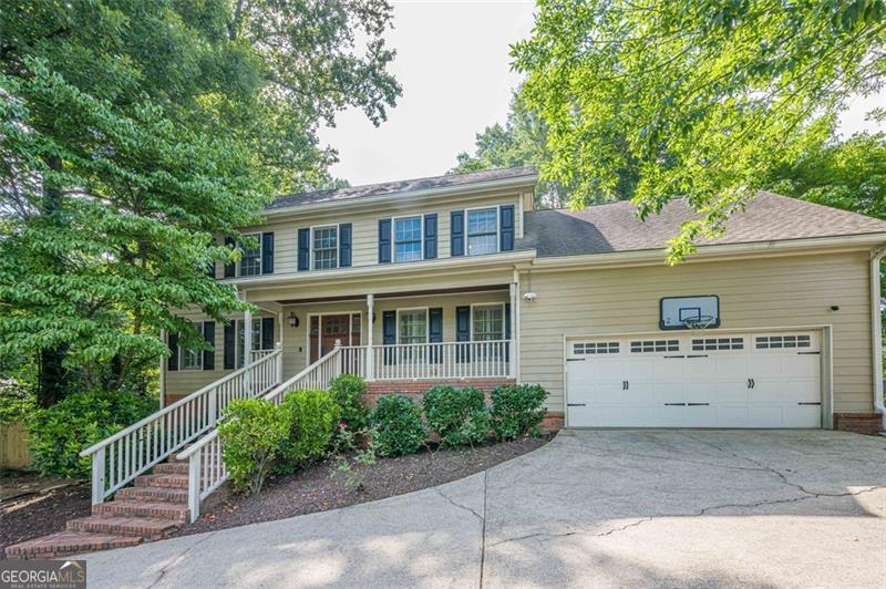 Ideally located just seconds from top-rated North Gwinnett High School, this 3 bedroom, 2.5 bath home offers both charm and functionality with a layout designed for everyday comfort and easy entertaining. Step onto the inviting front porch, featuring wood-planked ceilings, before heading inside, where the main level boasts a formal dining room, cozy living room with a fireplace and stunning built-ins, and a kitchen equipped with stainless steel appliances and a convenient custom drop zone by the garage-perfect for staying organized! The laundry room, just off the kitchen, also has a door leading straight out to the back deck, a thoughtful touch when you need to toss in a load after an afternoon of grilling or outdoor play. The sunroom- flooded with natural light and perfect for that morning cup of coffee- features the same rich wood-planked ceiling as the front porch, and opens to the fenced backyard. With a large custom deck, fire pit area, and garden beds ready for planting, this outdoor space is ready for entertaining or relaxation! Upstairs, the spacious primary includes not one but two closets-one large enough to function as a home office, workout space, or personal dressing room, and complete with a custom closet system. Two additional bedrooms and a full bath complete the upper level. The partially finished basement offers extra flexible space-ideal for a home gym, playroom, media room, or additional bedroom! Located in a sought-after school district and close to shopping, dining, and parks, this home combines location, comfort, and versatility- you don't want to miss this one!