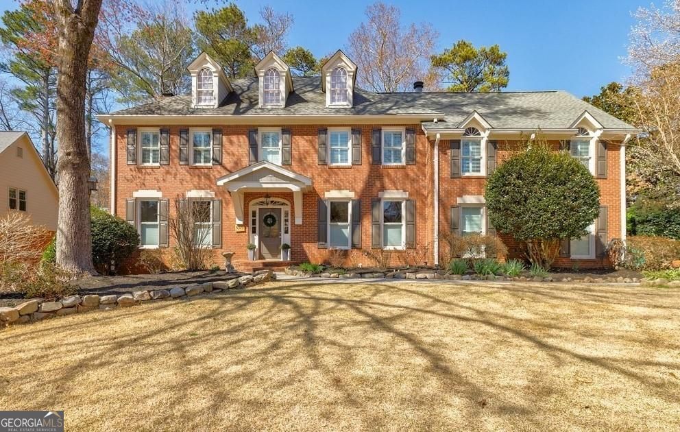 Welcome to 656 Gunby Road, located in the heart of Sibley Forest, one of East Cobb's most desirable neighborhoods. This beautiful three-sided brick home, featuring updated HardiePlank shingle siding and windows, is nestled within an active swim and tennis community. With playgrounds nearby and close proximity to the Chattahoochee National Forest, this home offers the perfect balance of serenity and outdoor recreation. Step inside to discover an impressive open floor plan on the main level, featuring newly refinished hardwood floors and a custom chef's kitchen. With high-end cabinetry, a Viking gas cooktop, double ovens, and a Sub-Zero refrigerator, this kitchen is perfectly designed for both casual meals and elegant entertaining. Beyond the kitchen, the main level boasts a bedroom and full bath off the mudroom, an inviting office, a spacious living room with a cozy fireplace, and a stunning sunroom with an abundance of windows, flooding the space with natural light. For added convenience, the garage is equipped with an electric car charger, making this home as functional as it is beautiful. Upstairs, you'll find four bedrooms with gleaming hardwood floors throughout. The master suite is a true retreat, boasting a private sitting room/ office, his-and-her closets, and a luxurious, newly updated bathroom with marble finishes and heated floors. Two secondary bedrooms share a beautifully designed Jack-and-Jill bath with custom stonework, while the fourth bedroom enjoys its own en-suite bath with stunning marble tile. The expansive finished basement is designed for entertaining, complete with a large gaming area, a bar, and an updated full bath with heated floors. You'll also find ample storage space and a cozy fireplace, one of three in the home, located on each level-including the main living room and the master suite. 656 Gunby Road is a blend of elegance, comfort, and convenience, offering an active lifestyle in a vibrant community, just minutes from nature and East Cobb's finest amenities.