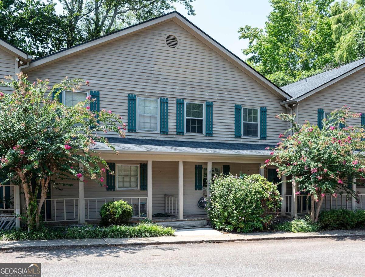 Welcome to this charming East Side Athens condo, perfect for game day enthusiasts, college students, investors looking for an income-producing property, or anyone seeking ultimate convenience. Situated just minutes from shopping, the UGA main campus (including less than 2 miles to the Vet School), Loop 10, entertainment, the Athens bus line, and more, this property offers an unbeatable location.    Step inside to discover an open and inviting main living area, ideal for entertaining. The spacious living room features a cozy wood-burning fireplace, a natural stone hearth, and a pine surround. The kitchen has plenty of cabinets and all appliances, making meal preparation a breeze.    Upstairs, the split-bedroom layout ensures privacy, with each bedroom featuring a private bathroom, large closets, and generous storage space. Durable LVP flooring throughout the home makes upkeep easy. One shower has been completely redone, and both bedrooms are equipped with new ceiling fans and remotes.    The fenced-in patio provides a perfect outdoor space for grilling, lounging in a hammock, or soaking up Georgias beautiful weather. Covered porches offer additional outdoor living areas, ideal for enjoying those cool spring and fall days. Fresh paint and other recent updates make this condo move-in ready!    Dont miss your chance to own this delightful condo in a prime location!