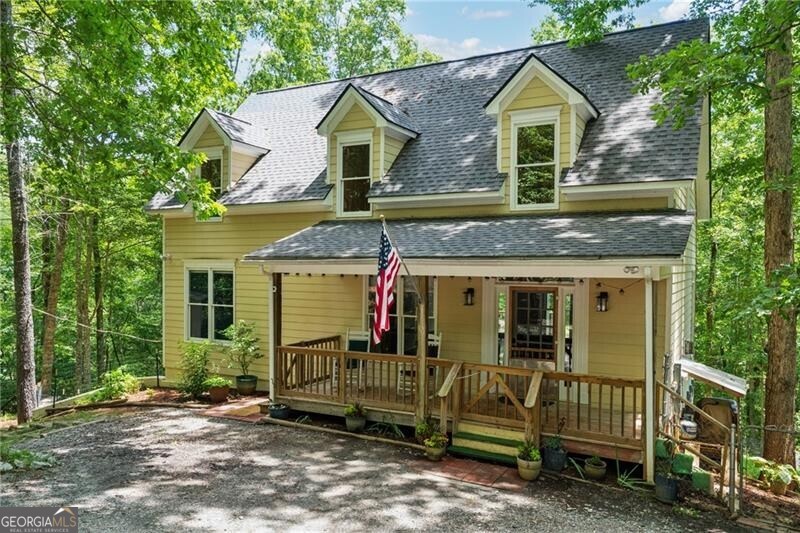 PRIVACY meets CONVENIENCE. Located just 4 miles from downtown Dahlonega, this beautifully secluded 4-bedroom, 3.5-bath home sits on a private 4.6-acre lot, offering peace and tranquility with the soothing sound of a creek's waterfall as your only neighbor. Priced well below a recent appraisal, this home is priced to sell. Key features include: master bedroom on the main level, a nicely appointed kitchen with stone counters, stainless appliances, and a gas stove; cozy den with a gas log fireplace for those cold evenings; two large upstairs bedrooms, a full bath, and a comfortable sitting area. The daylight basement offers an in-law suite possibility, with a bedroom, bath, sitting area, wood burning stove, and a partial kitchen area. Covered front porch, rear deck, basement patio with firepit, a fenced area in the backyard, and 2 storage sheds offer plenty of outside possibilities. This property offers the perfect balance of privacy and convenience with easy access to downtown Dahlonega and all the wonderful attractions of North Georgia. Whether you're looking for a peaceful retreat or a home with plenty of space for family and guests, this is an opportunity you won't want to miss!