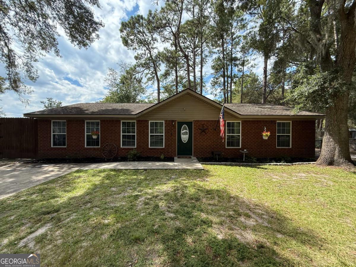 Charming and well-kept 4 bed, 2 bath home just minutes from Fort Stewart, schools, and shopping! This home features stainless steel kitchen appliances, laminate flooring in the main living areas, tile in the kitchen and bathrooms, and cozy carpet in the bedrooms. The architectural shingled roof adds both style and durability. Step outside to a spacious fenced in backyard, perfect for pets or entertaining guests. Enjoy evenings around the fire pit or get creative in the detached workshop-fully equipped with electricity. A perfect blend of comfort and convenience, this home is move-in ready and waiting for you!