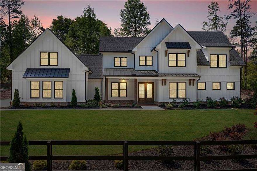 Step into timeless style and modern comfort with this stunning farmhouse retreat in Woodstock's sought-after Farm Gate community. Set on 1.38 acres of privacy and charm, this 7-bedroom, 6-bathroom estate is designed for those who crave both luxury and warmth.  Inside, soaring vaulted ceilings and natural light create an open, airy atmosphere. The spacious living room flows effortlessly into the show-stopping kitchen, where upgraded cabinets with custom inserts, exotic quartz countertops, and a farmhouse apron sink set the stage for effortless entertaining. A premium Zline appliance package-including a 36" gas stove with vent hood, microwave drawer, and refrigerator-makes every meal a chef's dream, while the oversized walk-in pantry ensures style meets function.  The primary suite is a true sanctuary with dual closets, a spa-worthy bath featuring a free-standing tub, and a Kohler shower system designed to impress. Upstairs, a finished flex space with a full bath offers endless possibilities-office, gym, or private suite.  Outdoor living is just as inviting, with a private patio perfectly placed off the dining and living areas. And for car enthusiasts or hobbyists, the expansive three-car garage provides ample room for storage, while the estate's generous lot delivers peace, privacy, and space to enjoy life at your own pace.  Farm Gate offers the best of both worlds-quiet, scenic surroundings just minutes from everyday conveniences. This is more than a home; it's a lifestyle. Don't miss your chance to make this extraordinary farmhouse your own.