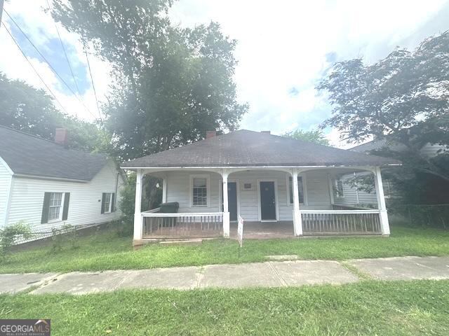 Welcome to this historic 2-bed, 2-bath duplex, offering a unique blend of vintage character and endless potential in the heart of Porterdale! This property boasts a beautiful open front porch, perfect for relaxing and taking in the charm of the neighborhood. The spacious back parking area provides convenience for tenants or owners alike. Inside, you'll find classic architectural details waiting to be restored to their former glory. Whether you're looking to renovate and maximize rental income or create a stunning owner-occupied property, this duplex is an ideal canvas for your vision. Located just minutes from local shops, dining, and entertainment, it's a prime opportunity in a one-of-a-kind community. Don't miss your chance to invest in this historic gem