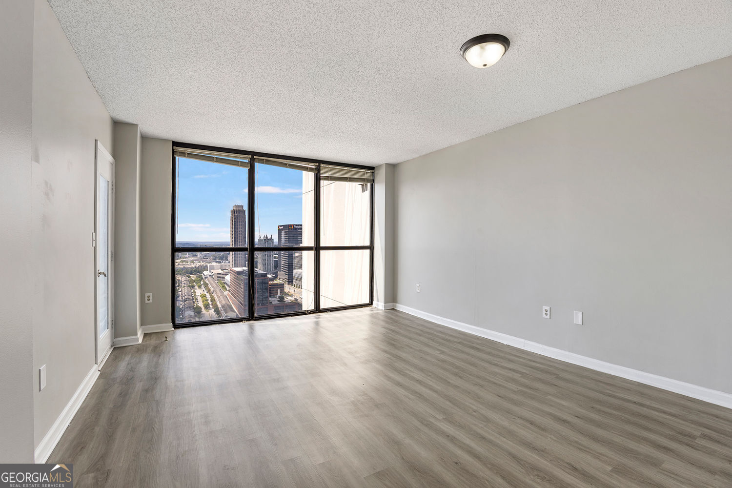 Welcome to Unit #3304 at 1280 West, a recently renovated 1-bedroom, 1-bathroom condo perched on the 33rd floor with stunning floor-to-ceiling windows and a private balcony that frame panoramic views of Downtown Atlanta, Mercedes-Benz Stadium, and Atlantic Station. Inside, the home features wide-plank luxury vinyl flooring, fresh neutral paint, and an open living/dining layout perfect for entertaining. The kitchen is updated with granite countertops, stainless-steel appliances, ample cabinet storage, and a passthrough to the main living area. The spacious bedroom offers direct balcony access, dual closets with mirrored doors, and a bathroom with a double vanity, granite counters, and updated fixtures. 1280 West offers unmatched amenities, including a fitness center, pool, tennis/pickleball courts, racquetball, half-court basketball, outdoor track, grilling stations, business center, billiards lounge, and 24-hour concierge service. Just steps from the Arts Center MARTA station with direct access to the airport, Buckhead, and Sandy Springs, and minutes from Piedmont Park, Atlantic Station, GA Tech, and the city's best dining and entertainment, this location offers true Midtown convenience.