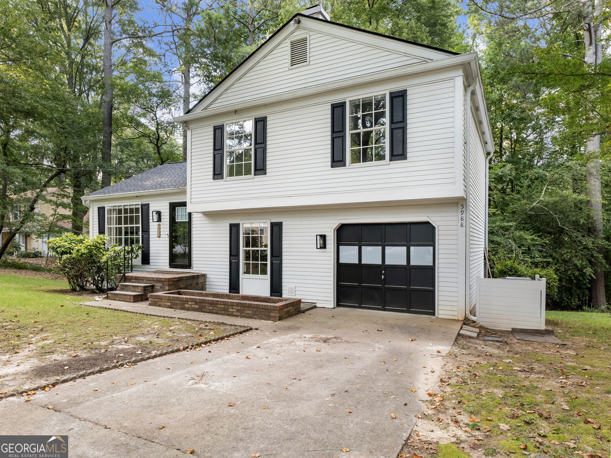 So much is NEW in this charming, recently renovated home, just a short walk from downtown Norcross with its adorable shops, dining, parks, and year-round events! New interior paint, new flooring, and upgraded design throughout! New roof and gutters installed in 2021. Enjoy the cathedral ceiling and open floorplan in the main living area with a spacious living room, dining room and bright, beautifully upgraded kitchen with newer stainless steel appliances, solid-surface countertops and handy island. Refrigerator stays! Find the owner's oasis upstairs with a generous primary bedroom with completely modern, renovated full bathroom featuring an oversized tile shower with frameless glass door, large vanity with storage and a high-end lighted mirror that lets you pick the light style. Upgraded Elfa closet systems in primary and one secondary bedroom. Two additional bedrooms share the hall bath, also fully renovated. Home offers additional living space on the lower level, with a large room with built-in brick fireplace that is an ideal space for a den, office, playroom or workout room. Relax on the screened porch while enjoying the peaceful, park-like backyard retreat. Oversized one-car garage offers storage options as well as parking. No HOA! Easy access to I-85, making your commute quick and easy. Nearby Peachtree Corners offers additional shopping, dining, and recreation. This home's incredible location along with its modern comfort combined with classic charm makes it a rare find! Come see it today!