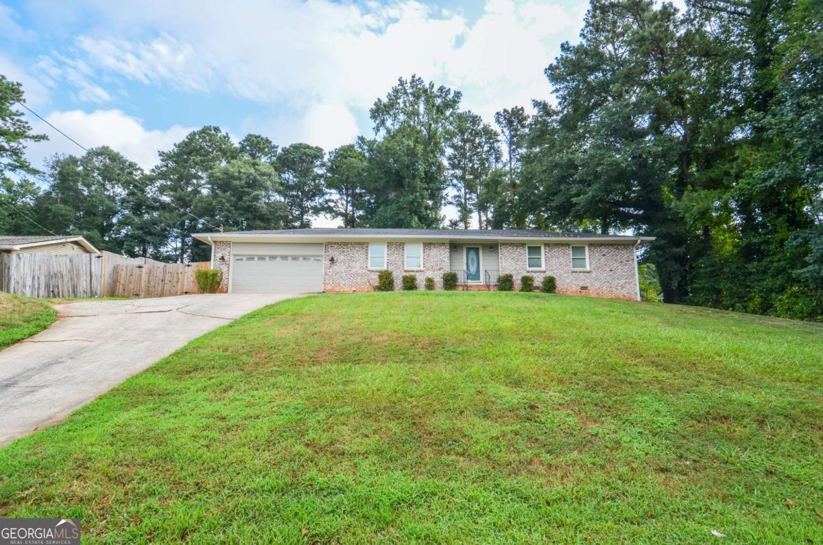 Welcome to 204 Caboose Lane, an updated brick-front ranch nestled in a quiet Woodstock neighborhood with no HOA or rental restrictions. This charming 3-bedroom, 2-bath home offers an inviting open floor plan starting with a welcoming foyer that leads into a spacious living room and large dining area, perfect for entertaining. The chef's kitchen is the heart of the home, featuring stainless steel appliances and plenty of counter space. The oversized primary bedroom includes a private en-suite bathroom and direct access to a sunroom that overlooks the expansive, fenced backyard - ideal for relaxing or hosting guests. Two additional generously sized guest rooms share a beautifully refinished hall bath. Thoughtful upgrades include new siding, soffit, fascia, and exterior paint (July 2023), along with a new roof (March 2021) and stunning bathroom renovations completed in 2023. Just minutes from the shops, restaurants, trails, dog parks, and live entertainment of Historic Downtown Woodstock, this move-in ready gem blends modern updates with unbeatable location and flexibility.