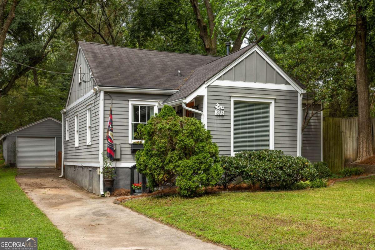 Full of charm and just blocks from East Atlanta Village, this bungalow is basically your Pinterest board come to life. This 2-bed, 2-bath gem is zoned for highly rated Burgess-Peterson Academy, so you can enjoy one of the best elementary schools in the area while being moments from EAV's coffee shops, dining, boutiques, and nightlife. Inside, gleaming hardwood floors, graceful arches, and perfectly preserved dental molding tell the story of a home with true character. The thoughtful layout tucks both bedrooms-with full bath access-privately away from the main living spaces, giving you the best of both comfort and function. The garage is ready for whatever you need-parking, storage, or that dream home gym. Out back, it's pure magic: a fully fenced yard with a newly stained deck for al fresco dinners, a cozy fire pit for chilly nights, and a lush garden that'll make you forget you're in the city. From weekday coffee runs to weekend backyard hangs, this home delivers the very best of EAV living in one perfect package.