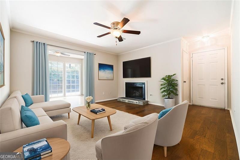 Convenient to I-75/I-285, this updated condo with a spacious two-bedroom floorplan is top notch. Be greeted by a foyer into a large, light-filled living space with fireplace and a sunroom with three walls of windows and patio access. Separate dining area views into the renovated kitchen. The primary bedroom is large with a walk-in closet and the additional bedroom is also spacious and has direct access to the rear patio (also accessible from the sun room). The renovated bathroom features an oversized vanity and separate water closet with renovated shower. Laundry room + utility closet is well-sized.Plenty of storage + great flow minutes from Atlanta proper. Community swim, tennis + more. Minutes from Truist Park!