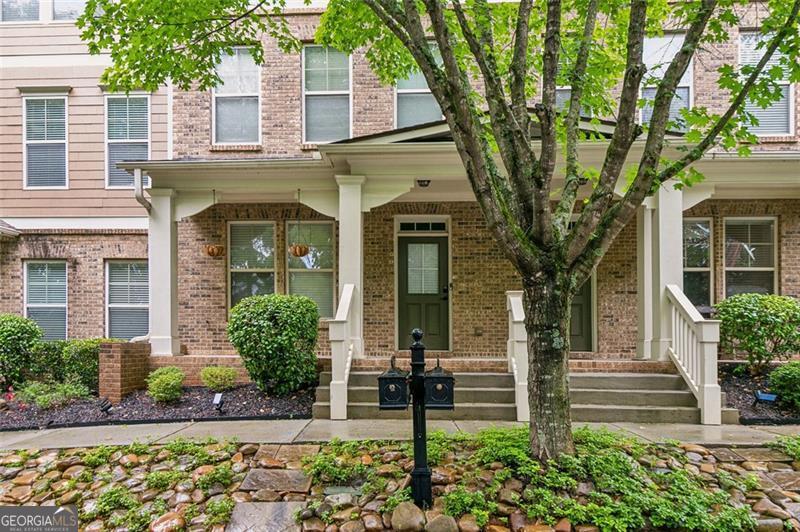 Motivated Seller!!! Welcome to your next home in Suwanee's premier Village Grove community. This beautifully maintained 3BR/3.5BA townhome offers three spacious levels with an open-concept layout and thoughtful upgrades throughout. The kitchen features bright white cabinetry with matte black hardware, granite countertops, stainless steel appliances, and a striking custom black island with dual sinks-complemented by brand new flooring installed in July 2025. Two metal basket ladder shelves offer stylish open storage, and just off the kitchen, a private deck provides the perfect spot for morning coffee or evening relaxation. Black-and-white handrails with gold-tone hardware add a refined touch that echoes the home's modern finishes. Each bedroom includes a ceiling fan and its own custom paint accent wall. A bold accent wall in the main living area is flanked by two built-in ladder-style bookcases-ideal for a home office or bar setup. Additional features include three mounted TVs that remain with the home, a Whirlpool washer, and updated matte black hardware in the main bathrooms. The spacious owner's suite includes a spa-like bath and a walk-in closet. Steps from Sims Lake Park and walkable to the new Town Center on Main, this swim/tennis community is served by North Gwinnett's award-winning schools and offers green spaces, trails, and HOA-covered exterior maintenance for hassle-free living.