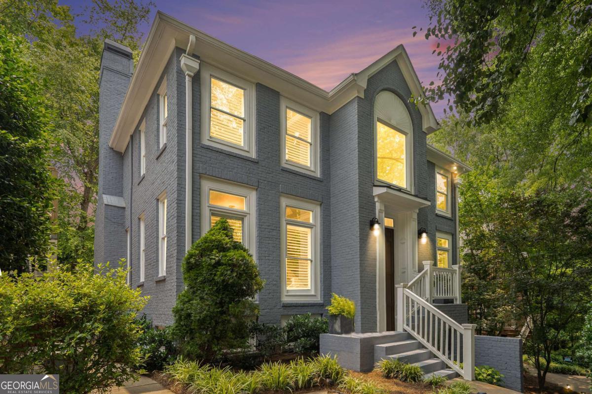 This beautifully renovated brick home is tucked away in a private enclave of just nine homes in Sandy Springs, offering the privacy of a single-family home with the low-maintenance lifestyle of a townhome. Surrounded by windows, the home is filled with natural light, and features hardwood floors on both the main and upper levels, plantation shutters, and a private deck. The chef's kitchen is a standout, showcasing granite countertops, a walnut island top, Dacor appliances, upgraded cabinetry, a pantry, dumb waiter from garage and private wet bar-perfect for entertaining. The kitchen opens to a cozy family room with a gas fireplace and built-in speakers, which seamlessly connects to the formal living room. A grand two-story foyer and formal dining room add to the home's elegant flow and functionality. All bedrooms offer ensuite baths, and the primary suite features two large walk-in closets. The expansive daylight basement/rec room with tiled floors provides endless flexibility and could easily accommodate a 4th bedroom and full bath, thanks to an oversized laundry room and existing exterior access-ideal for a private suite or guest quarters. A touch of green space behind the driveway allows for small plantings or garden beds. This is a rare opportunity to enjoy elegant, turnkey living in a quiet, upscale Sandy Springs location, just minutes from 400 & 285 major commuter routes plus shopping, dining just down the street!