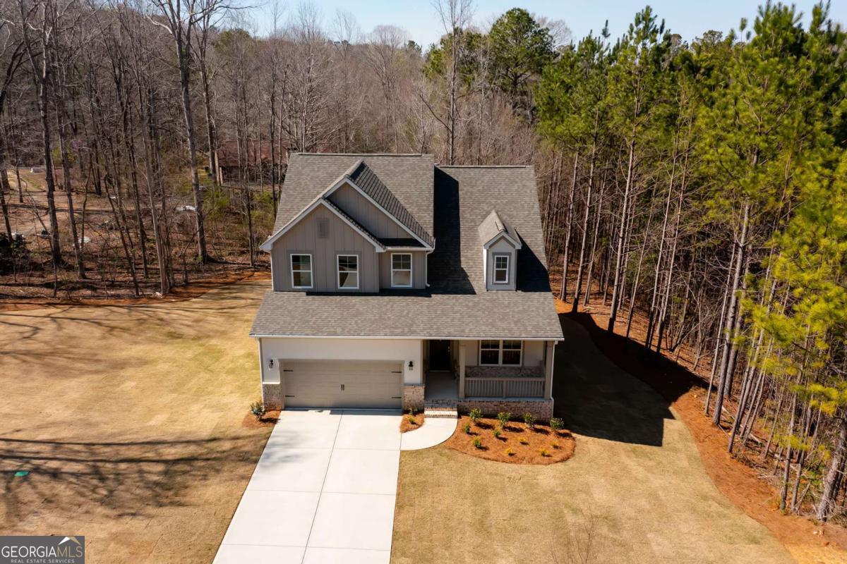 Welcome to The Alexander at High Shoals, a thoughtfully designed 3-bedroom, 2.5-bathroom home situated on a private wooded lot just 2 minutes from the scenic High Shoals Falls. This open-concept layout features stainless steel appliances, gray cabinets, and modern finishes that create a clean, contemporary feel. The spacious living area is ideal for both everyday living and entertaining. The owner's suite offers a quiet retreat with crown molding and natural light, while secondary bedrooms provide flexibility for guests, family, or a home office. Step onto the back deck and enjoy a peaceful wooded view. With no HOA and generous builder incentives, this home blends style, privacy, and outdoor living. This is a new construction home. Photos are representative of the Alexander floor plan and may not reflect the actual home.