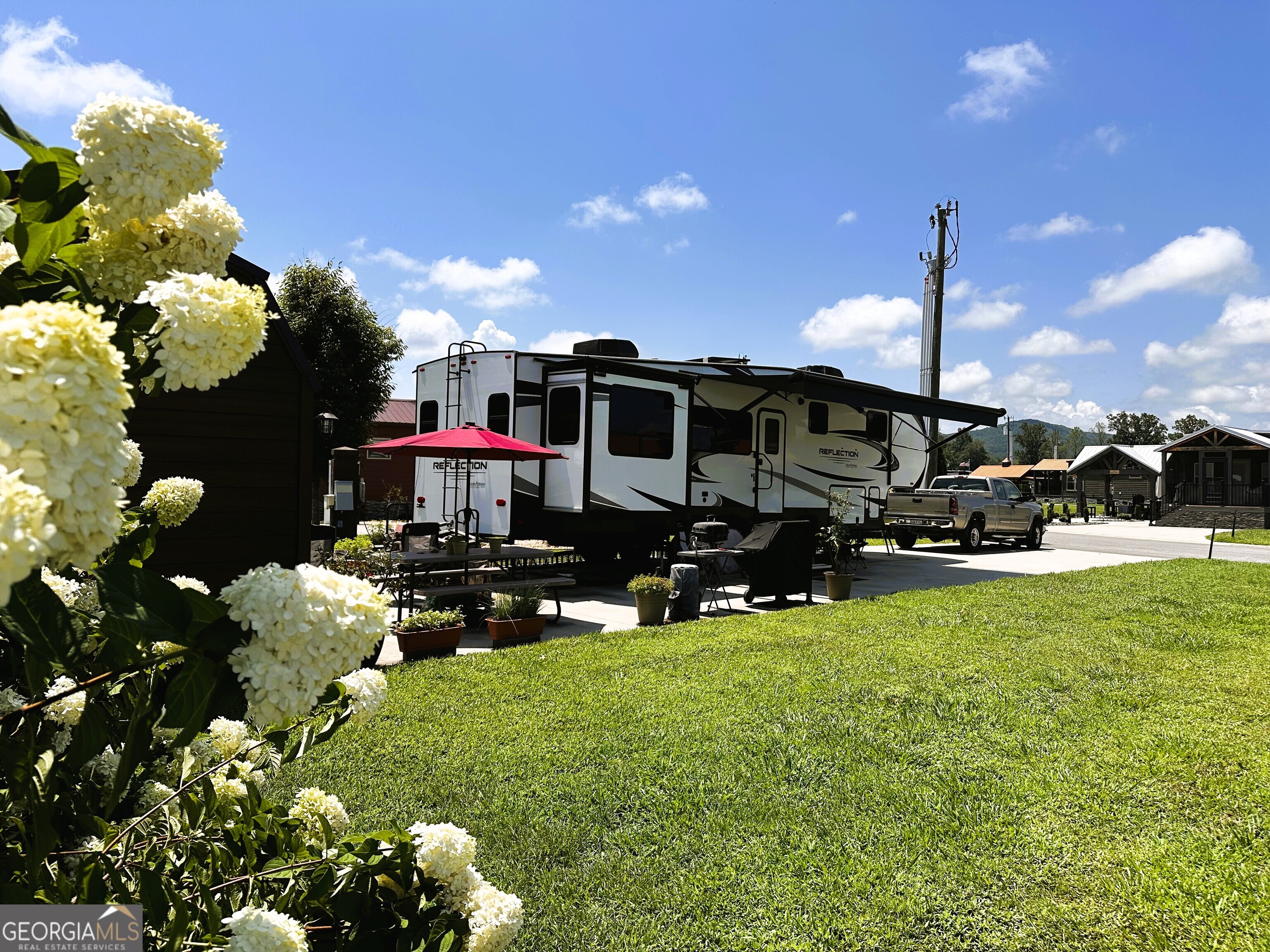 RV lot that will handle the largest of rigs and room to add a tiny home! Plenty of room for your vehicles and golf cart! Large shed with electric for all your toys or additional storage. Area for firepit. Close to resort green space to keep an open feel and mountain views! A beautiful vacation lot, future permanent residence or rental property. Local lender financing available! Crossing Creeks RV Resort and Spa welcomes class A,B and C RV's, as well as travel trailers and 5th Wheels!