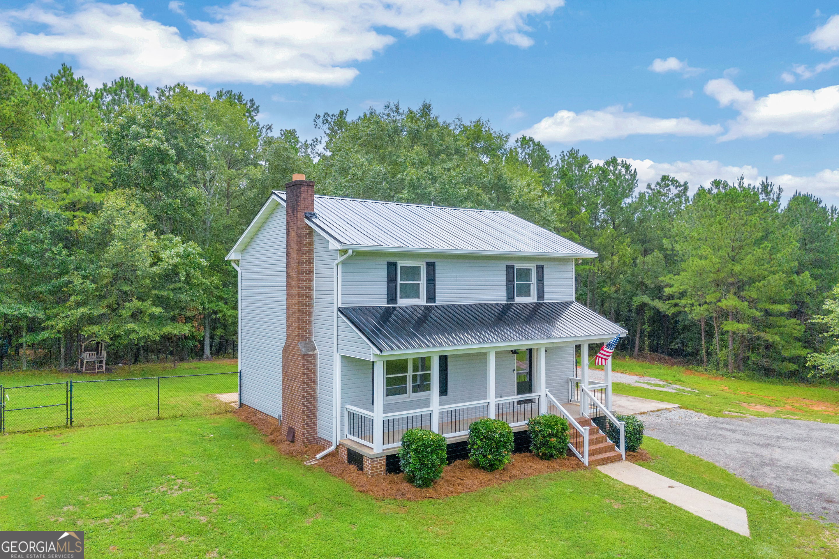 Remodeled farmhouse on 2.5+ acres fenced for your animal friends and ready to move in! This home is in the Youth school district and close to everything including shopping, dining, and schools. It features 3 bedrooms and 2.5 bathrooms, a large eat-in kitchen with stainless steel appliances, a foyer entrance w/ drop zone, and a large family room w/ a true masonry fireplace. Renovations include new flooring, new roof, fresh interior paint, new light fixtures, and more! All of this on one of the prettiest roads in Walton County!