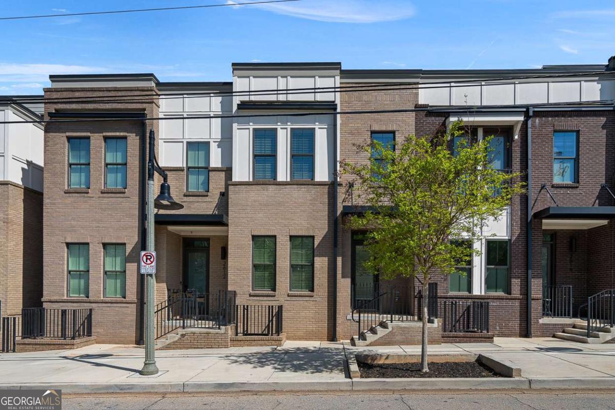 Top School districts and walkable to Downtown Decatur! 2614 Talley St-a 5-bedroom, 4.5-bathroom, practically new townhome in the heart of Talley Street Station, built by Toll Brothers. Step inside to an open-concept main floor that flows effortlessly: a spacious dining room, a luxe kitchen with a coffee bar, and a living area begging for your oversized sectional. Upstairs, the primary suite shines alongside two additional bedrooms and a full bath-ideal for family or guests. Climb to the top level, and you'll find a fourth bedroom, another full bath, and a loft-style entertaining space opening to a rooftop terrace. Picture this: turf, stylish outdoor furniture, string lights, and pre-plumbed gas and water lines ready for your dream outdoor kitchen. Head downstairs from the main level, and a fifth bedroom with its own full bath, large closet, and access to a two-car garage rounds out this flexible, sprawling layout. This gem sits just a mile from downtown Decatur, an eclectic, charming, almost magical spot that's a rare treat in Metro Atlanta. You're close enough to stroll to the vibrant square, yet tucked away from the premium downtown price tag-delivering unbeatable value under $1 million. Zoned for top-tier Decatur schools, it's the perfect blend of location, livability, and affordability. This isn't just a house-it's a lifestyle. Tons of space, endless possibilities, and a prime spot in one of Atlanta's best neighborhoods. This complex currently has rental permits available right away. Buy it as a residence or buy it as an investment, either way this provides added flexibility for use of the property! Don't miss your chance to call 2614 Talley St home, you will love it!