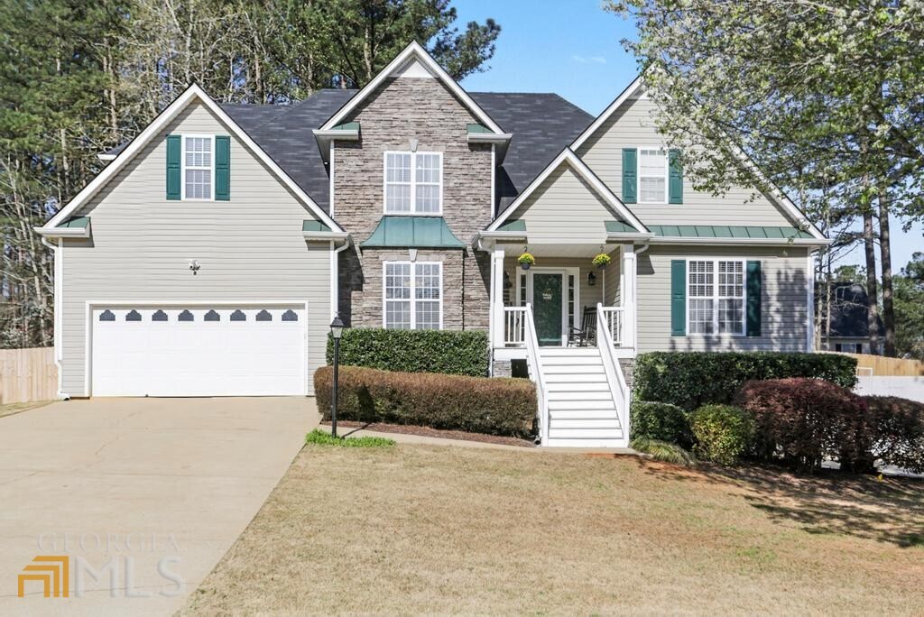 The upgrades are endless in this gorgeous traditional home in sought after Canterbury Lane! Situated on a corner lot, this spacious floor plan provides 4 bedrooms plus bonus room including primary on main with walk in closet and huge soaking tub. Natural light fills the 2 story foyer where you are greeted with laminate flooring that continues throughout the living and dining rooms. A stacked stone gas fireplace welcomes you into the living room that leads to a sunny breakfast room overlooking the back yard. The roomy kitchen offers plenty of counter space, stainless steel appliances and a newly installed sink. A laundry room off of the kitchen has a fresh remodel. The formal dining space with crown molding provides the perfect spot for large gatherings. New carpet upstairs leads to 3 secondary bedrooms, a bonus room and a full bathroom. The finished basement provides 2 more bonus rooms, a kitchenette and full bathroom in addition to a rec room. The basement has additional storage/workshop space and separate entry and driveway. The private fenced back yard is the perfect spot to enjoy the outdoors with multi-level decks, beautiful landscaping and fire pit. If you are looking for move in ready, this is the one! Active swim and tennis community convenient to shopping and restaurants in both Douglasville and Hiram. Easy access to I-20.