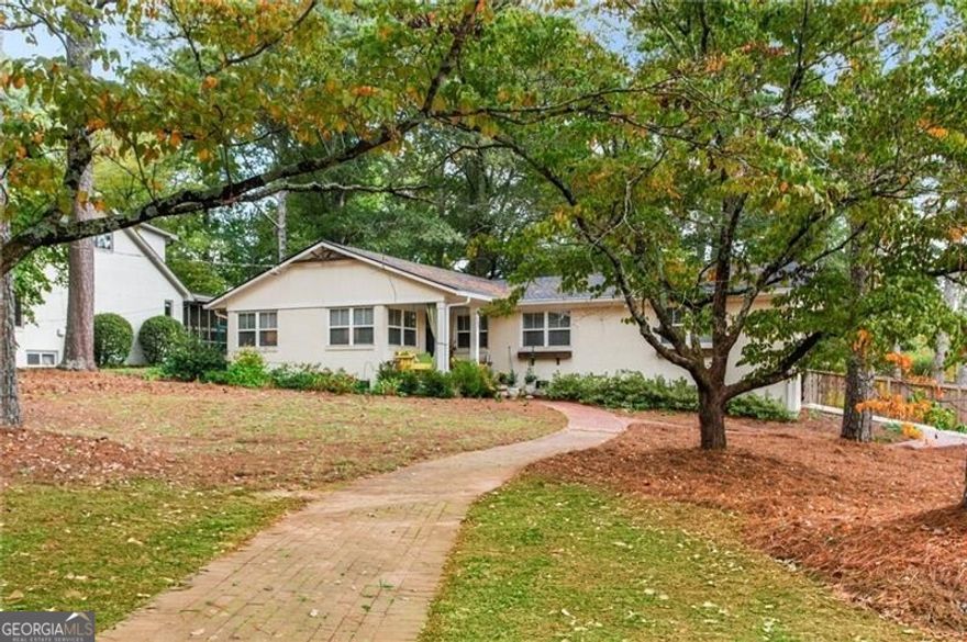 Absolutely phenomenal renovated ranch in West Side Elementary District about 1 mile west of the Marietta Square, right outside the gates to Anderson Farm.  The home was totally renovated in 2021 and included a new roof, kitchen, baths, systems and windows.  Gorgeous open concept kitchen with white cabinets, quartz counters, stainless appliances and a large island looking out to the living room.  Upgraded designer light fixtures throughout, gorgeous REAL hardwoods in every room, Carrera marble topped vanities in the bathrooms, and the have added a beautiful large deck on the rear of the home perfect to end-of-summer BBQ get togethers!  Large level lot with the backyard fenced in.  1 Car carport plus an additional 2 spaces on a parking pad.  And to top it all off --- there's a spectacular view of Kennesaw Mountain from the front porch!