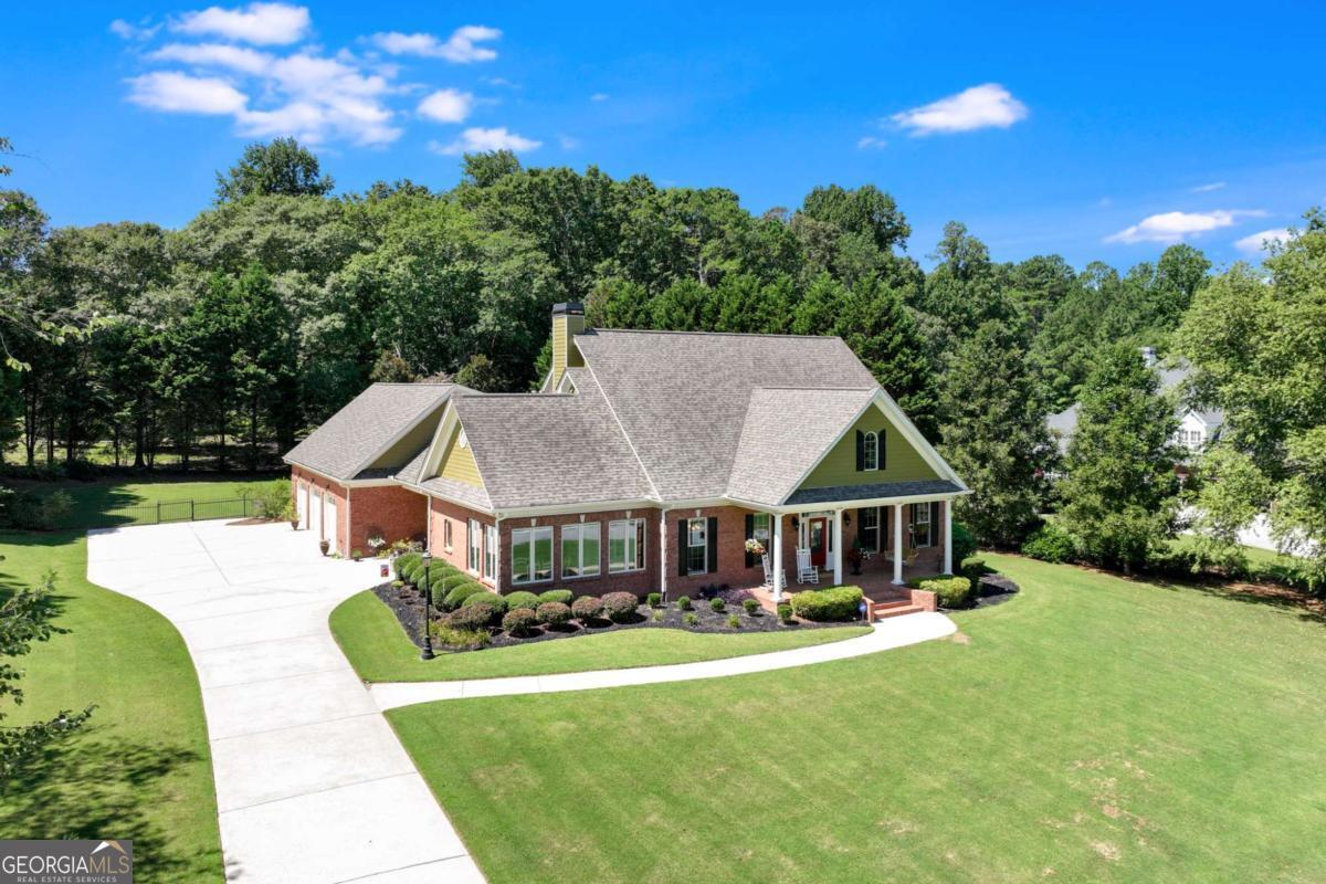 Exquisite, Elegant & Inviting! This beautiful Custom Brick home has everything you could ever want or need plus MORE! Great Location for easy access to 316 to shopping and restaurants near this COVETED QUIET CUSTOM NEIGHBORHOOD. A THREE car garage with easy access from a level driveway. ENTER through the rocking chair brick front porch or the beautiful side entryway with separate foyer. IT IS LOVE AT FIRST SIGHT as you enter this LIGHT BRIGHT home which features a large living area as the central gathering place featuring BUILT IN BOOKSHELVES & STUNNING FIREPLACE overlooking the SUNROOM with custom made plexi glass windows for year round use. The large dining room gives easy access to the custom kitchen which features windows all around in the breakfast room/kitchen area where you can enjoy watching the birds during your morning coffee. A serving bar, custom cabinets and excess counterspace plus you will enjoy the large pantry, cooking space & separate icemaker. A large owners suite on the first floor featuring a pocket access door into the separate office space which could easily be a nursery or sitting area featuring a SECOND FIREPLACE and BUILT IN BOOKSHELVES. A LARGE BONUS room with full bath & walk in closet could be a teen suite or bedroom also but is currently the Entertaining Room/Hobby Room. TWO STAIRCASE entries to the upstairs featuring large bedrooms and walk in closets with walk in attic access PLUS A SECOND LAUNDRY ROOM make this a home that fits everyone! BUT THE BEST PART IS THE SALTWATER POOL, PERGOLA, WHIRLPOOL, OUTDOOR BRICK FIREPLACE, OUTDOOR KITCHEN w/ icemaker & RETRACTABLE AWNING & HALF BATH EXTERIOR ACCESS which is a garden of blooming Jasmine, blueberries, azaleas, roses, lillies while sitting under the PERGOLA! FULLY FENCED with iron & gate fencing with a separate exterior access for those guests fortunate enough to be invited to your OUTSIDE OASIS! 3 FIREPLACES! This home is exquisite beyond measure. OPEN HOUSE JULY 27th 2-4 PM.