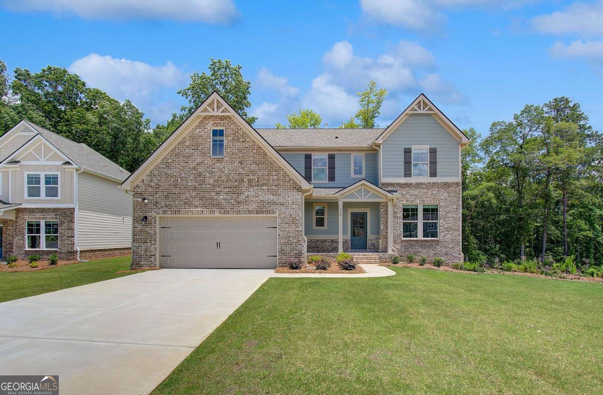 READY RIGHT NOW! Welcome home to Kingston, nestled in a sought-after gated community in Locust Grove and thoughtfully crafted by DRB Homes! This stunning single-family home boasts an exquisite craftsman-style exterior and is designed to impress with every detail. Our spacious Lauren II floor plan, situated on a slab foundation, offers 5 bedrooms, 3 full bathrooms, and a half bath. The owner's suite on the main level is a luxurious retreat, complete with a large walk-in shower, a separate soaking tub, and dual vanities. The 5th bedroom upstairs provides flexibility and could easily serve as a home office, perfect for today's lifestyle. Step inside to discover a formal dining room with elegant coffered ceilings and a gourmet kitchen featuring quartz countertops, an expansive kitchen island, beautiful cabinetry, stainless steel appliances, and a spacious walk-in pantry. The open floor plan flows seamlessly, creating a welcoming environment for both everyday living and entertaining. Upstairs, you'll find a bright and inviting loft, a large media room, and ample space for family and guests. This home also includes a full unfinished basement, offering endless possibilities for additional living space or storage. Outside, enjoy the tranquility of a wooded backyard and the convenience of a 2-car garage. Amenities for the community include a clubhouse and pool, enhancing the lifestyle opportunities at Kingston. Generous incentives are available toward closing costs with an approved lender, making this the perfect time to make this exceptional home yours. *Please note: The main photo is of the actual home; interior photos and virtual tours are of a decorated model or spec home.* Please note: If the buyer is represented by a broker/agent, DRB REQUIRES the buyer's broker/agent to be present during the initial meeting with DRB's sales personnel to ensure proper representation.