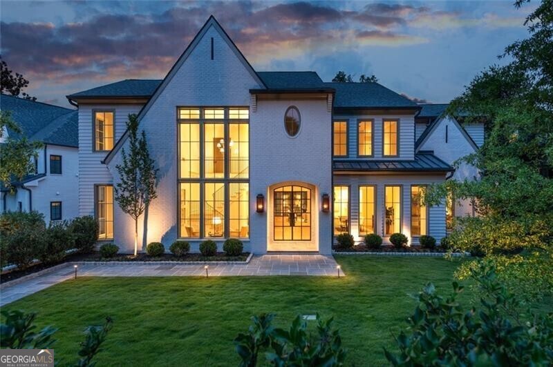 Absolutely impeccable brand-new construction home on one of Ansley Park's premier streets! Completed by renowned builder Stokesman Luxury Homes , this flawless residence epitomizes refined luxury coupled with the highest quality finishes - no detail was overlooked ! The impressive entry way features gorgeous custom iron doors leading to an open floor plan designed to maximize space for entertaining. Sophisticated yet comfortable , the main level boasts 1 of 2 luxurious primary suites , a separate office , formal dining area, and a large family room with limestone fireplace and built-ins. The high-end kitchen features all top-of-the-line Thermador appliances, a large island, marble countertops , custom cabinetry, hand hammered metal hood, a wet bar and a separate scullery with a tremendous amount of storage. The custom iron windows along the back of the living room showcase the inviting outdoor terrace which boasts a dipping pool & spa, covered outdoor fireplace and a built-in grilling area. On the second level you'll find another exquisite primary suite with dual walk-in closets, stunning designer bathroom with a soaking tub and shower with 5 showerheads. Plus, its own private outdoor terrace with gas fireplace. In addition, there are 3 large ensuite secondary bedrooms all featuring a walk-in closet. The light-filled third floor features a large living area that would make a great playroom , TV room or gym. In addition, there is another outdoor terrace with gas fireplace , a guest room or office and an additional full bathroom. The terrace level boasts high ceilings and would make a great media room or game room. A generous guest suite completes the terrace level. Other highlights include: an elevator to all 4 levels , a private putting green , 3 car garage, 10' ceilings, hardwoods throughout, gas lanterns, custom metal handrails, professional landscaping and so much more! Every inch feels like a custom-built home - bring your most discerning buyers! Unbeatable location within walking distance to Piedmont Park , High Museum, Colony Square, Peachtree Street, ASO and 5 neighborhood parks. This one checks every box!