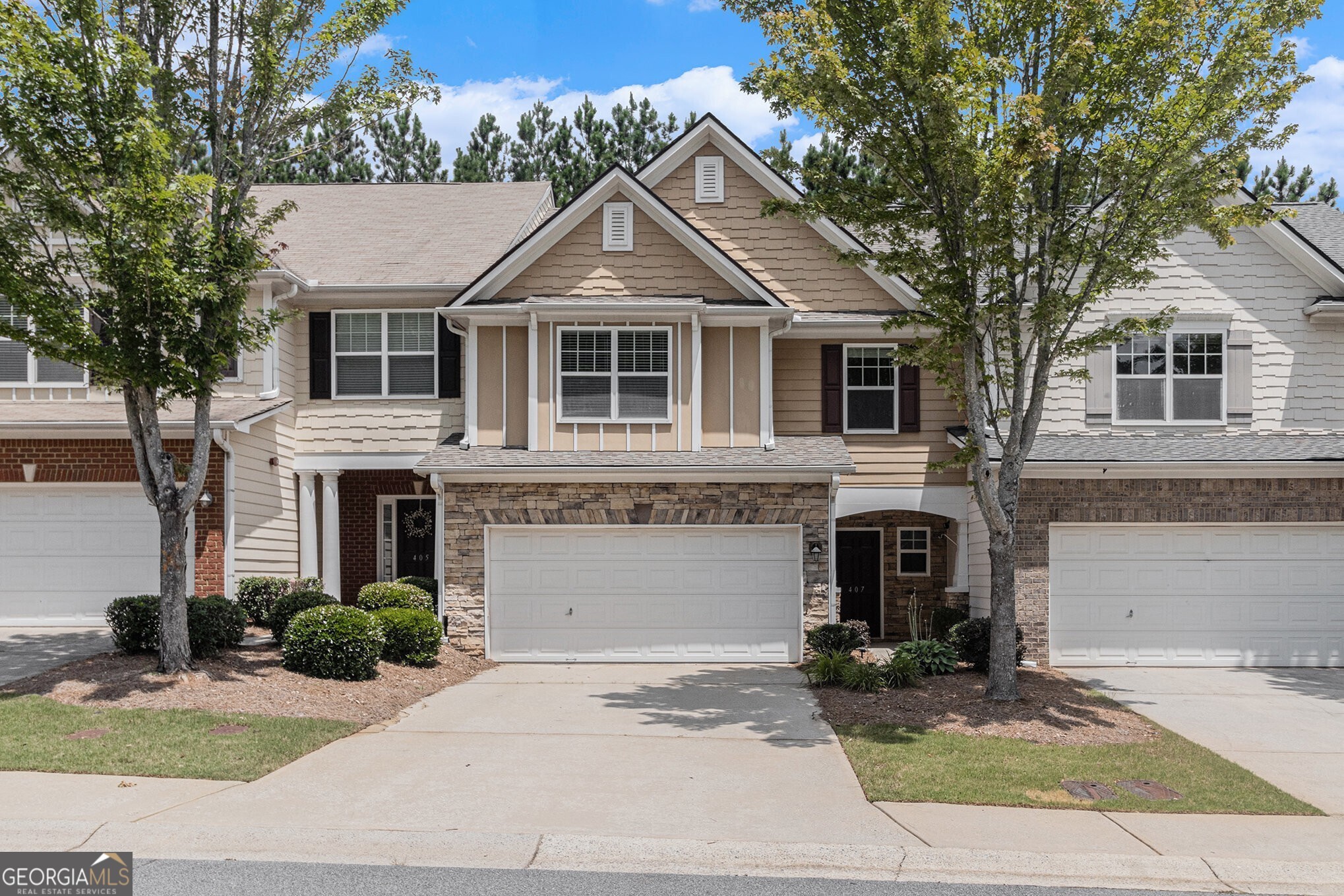 Modern Comfort Meets Natural Charm in this Beautifully Updated Townhome, ideally nestled in the Heart of the Sought-After Mountain Brook Community Complete with Swim, Trails, and a Private Lake! Thoughtfully Maintained and Recently Upgraded, this home features a Fully Renovated Kitchen and New HVAC System, both completed in June 2025, offering peace of mind and stylish functionality for years to come. Step into a Bright and Open Main Level, perfect for both Everyday Living and Effortless Entertaining. The soaring Two-Story Living Room is filled with Natural Light from an Abundance of Windows and centers around a Cozy Gas Fireplace. The Spacious Dining Area highlights Timeless Details like Crown Molding and Wainscoting, while the Renovated Kitchen showcases Quartz Countertops, Stainless Steel Appliances, Freshly Painted Gray Cabinets, a Breakfast Bar, and a Walk-In Pantry. A convenient Main Level Half Bath adds everyday ease. Upstairs, the Oversized Owner's Suite provides a Serene Retreat with Trey Ceilings, a Spa-Inspired Bathroom complete with a Glass Shower and Bench, Double Vanity Sinks, and a Large Walk-In Closet. Two Additional Bedrooms and a Full Bath offer Flexibility for Guests, Family, or a Home Office. Step outside to enjoy a Private Walk-Out Patio and Grassy Yard ideal for Pets, a Garden, or Weekend Grilling. Additional Upgrades include a New Roof, Washer, Dryer, and Refrigerator all under 3 Years Old plus the Updated Kitchen and New HVAC System, just completed this year. Take in the Natural Beauty of the nearby Lake and Walking Trail, or enjoy Resort-Style Amenities including a Swimming Pool, Playground, and Miles of Trails. Conveniently Located near HWY 92 with Easy Access to 575 and 400, and just minutes from Downtown Woodstock, Roswell, and Marietta this is the Lifestyle You've Been Looking For.