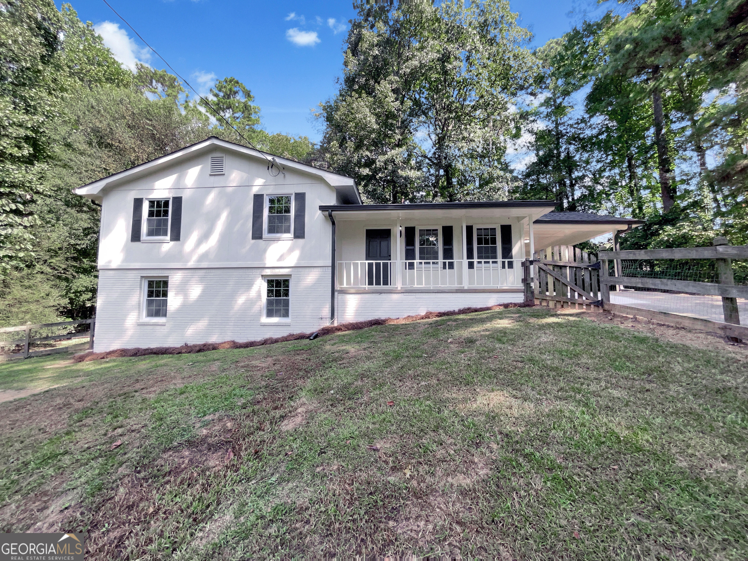 Welcome to this charming home tucked away in a quiet cul-de-sac within the sought-after East Paulding School District. Recently renovated, it features fresh paint, stylish lighting, and beautiful hand-scraped engineered hardwood floors. The cozy kitchen with white cabinetry flows into a separate dining room that opens to the patio-perfect for entertaining or enjoying outdoor meals. A spacious formal living room offers plenty of natural light, while the separate den showcases a stunning floor-to-ceiling rock fireplace. The finished lower level includes additional living space, laundry room, and additional storage space. Enjoy the fenced front yard, ideal for pets or play. Clean, updated, and full of character-this home is ready for its next owner!